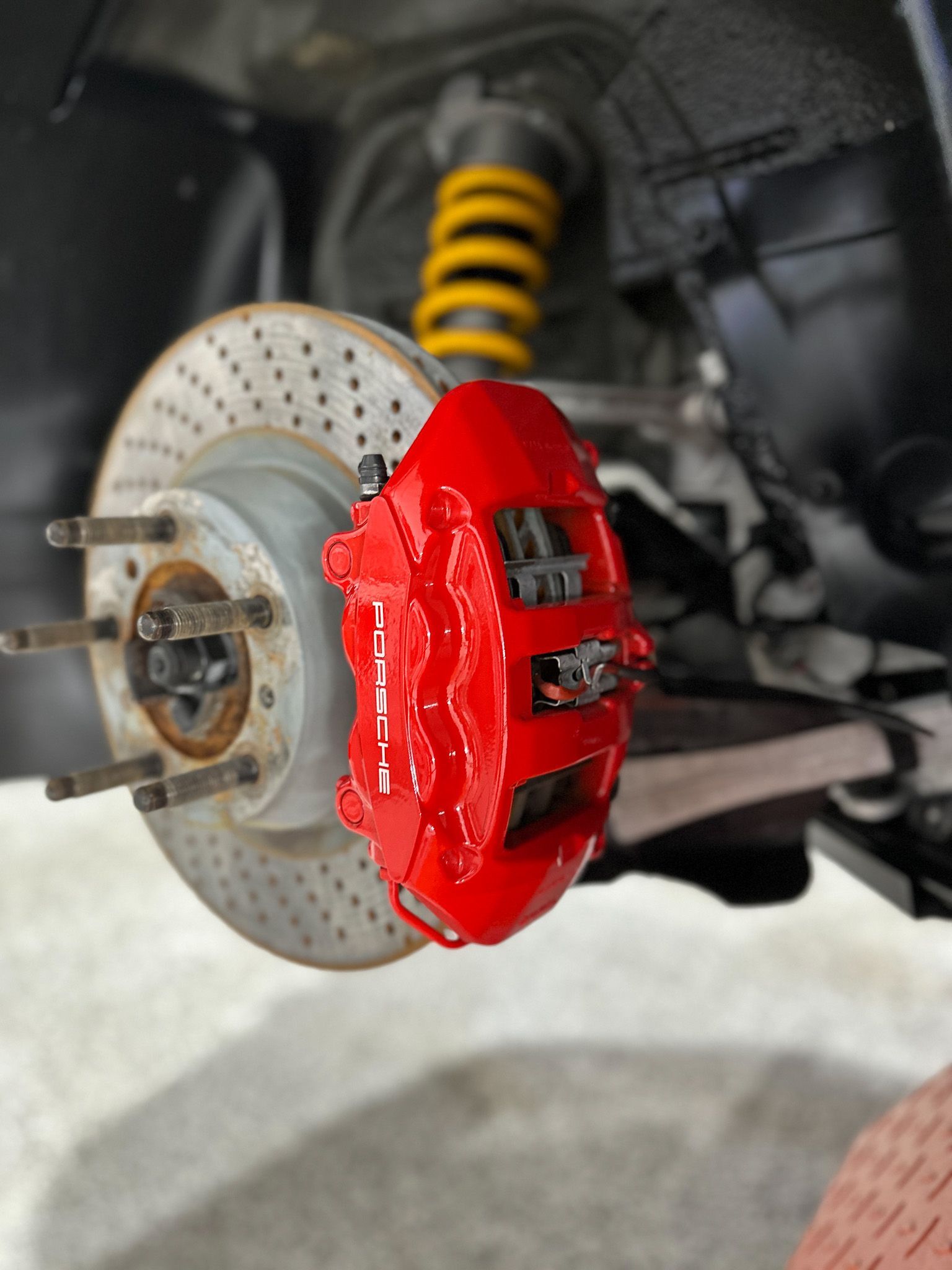 A close up of a red brembo brake on a car