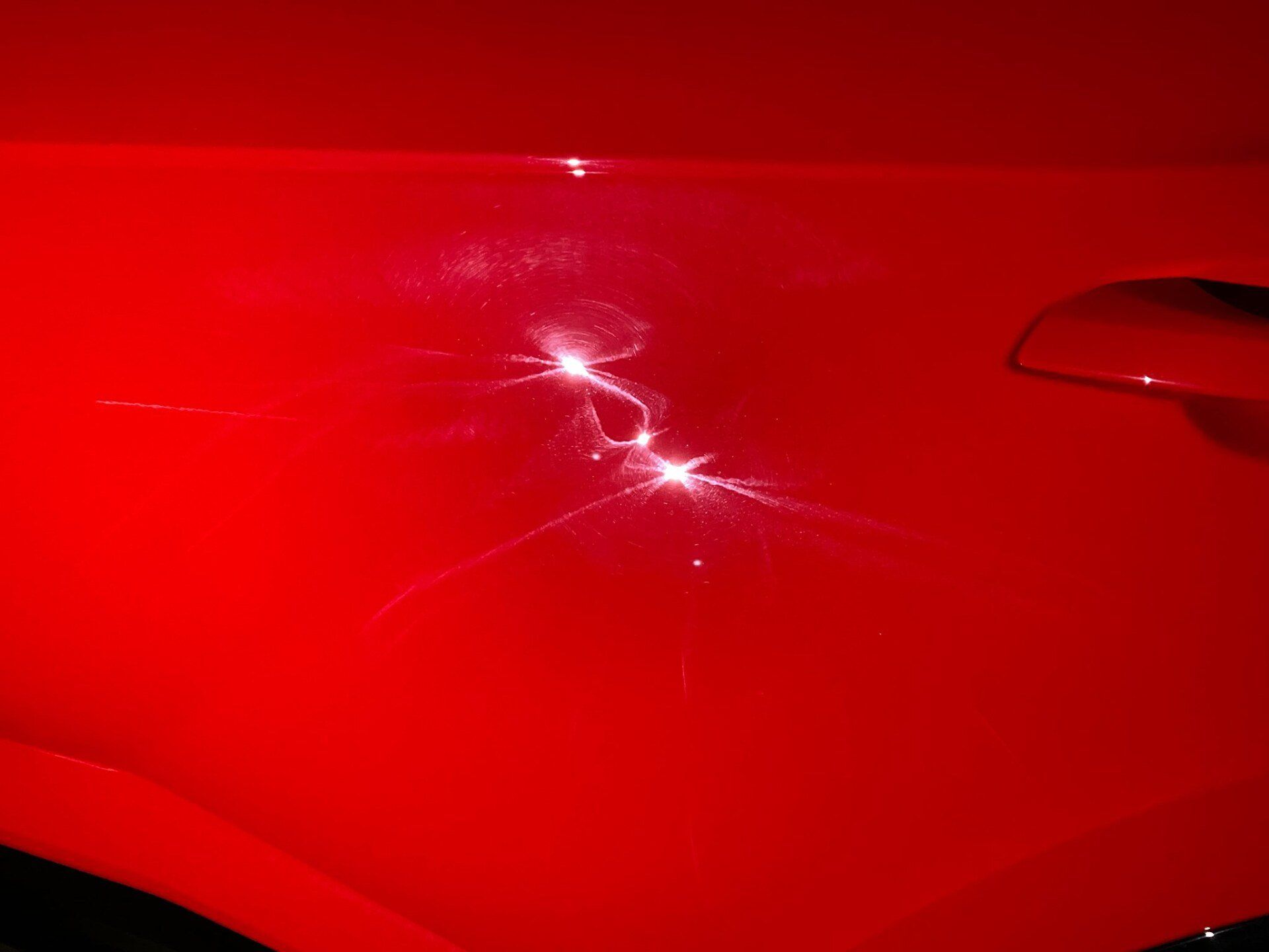 A close up of a red car with a lightning bolt on it