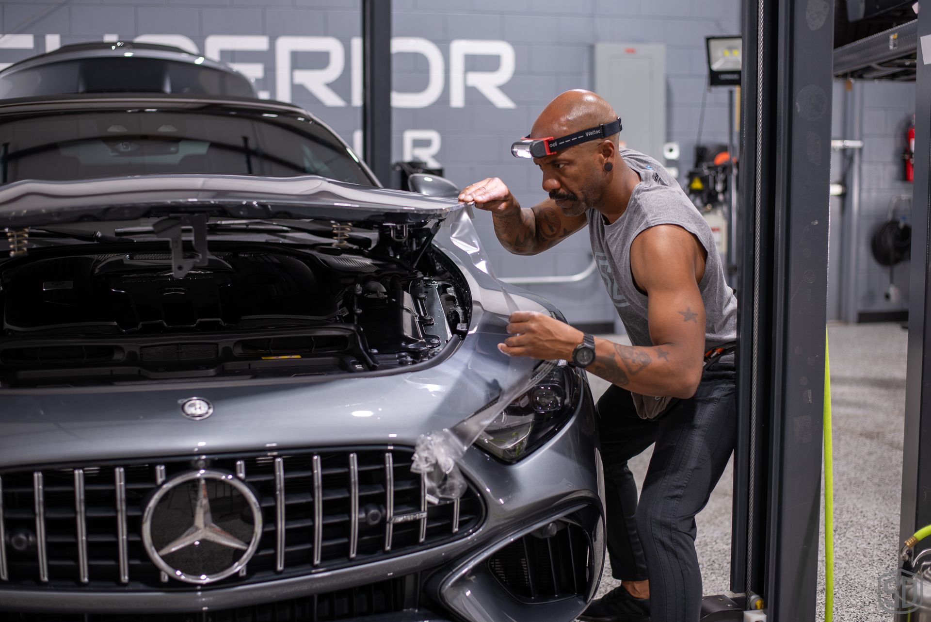 Karim carefully installing PPF on vehicle
