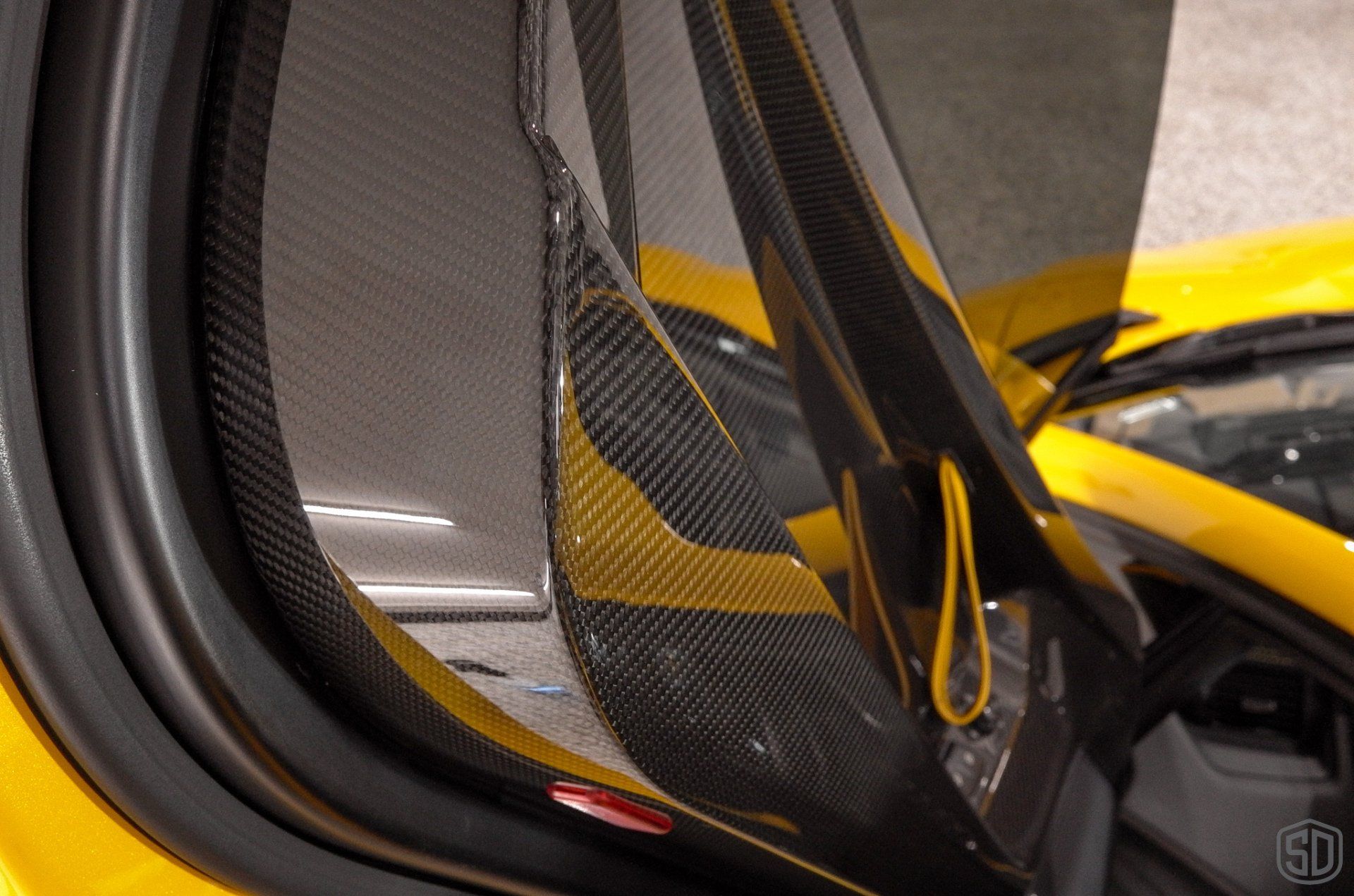 A close up of a yellow car with the door open