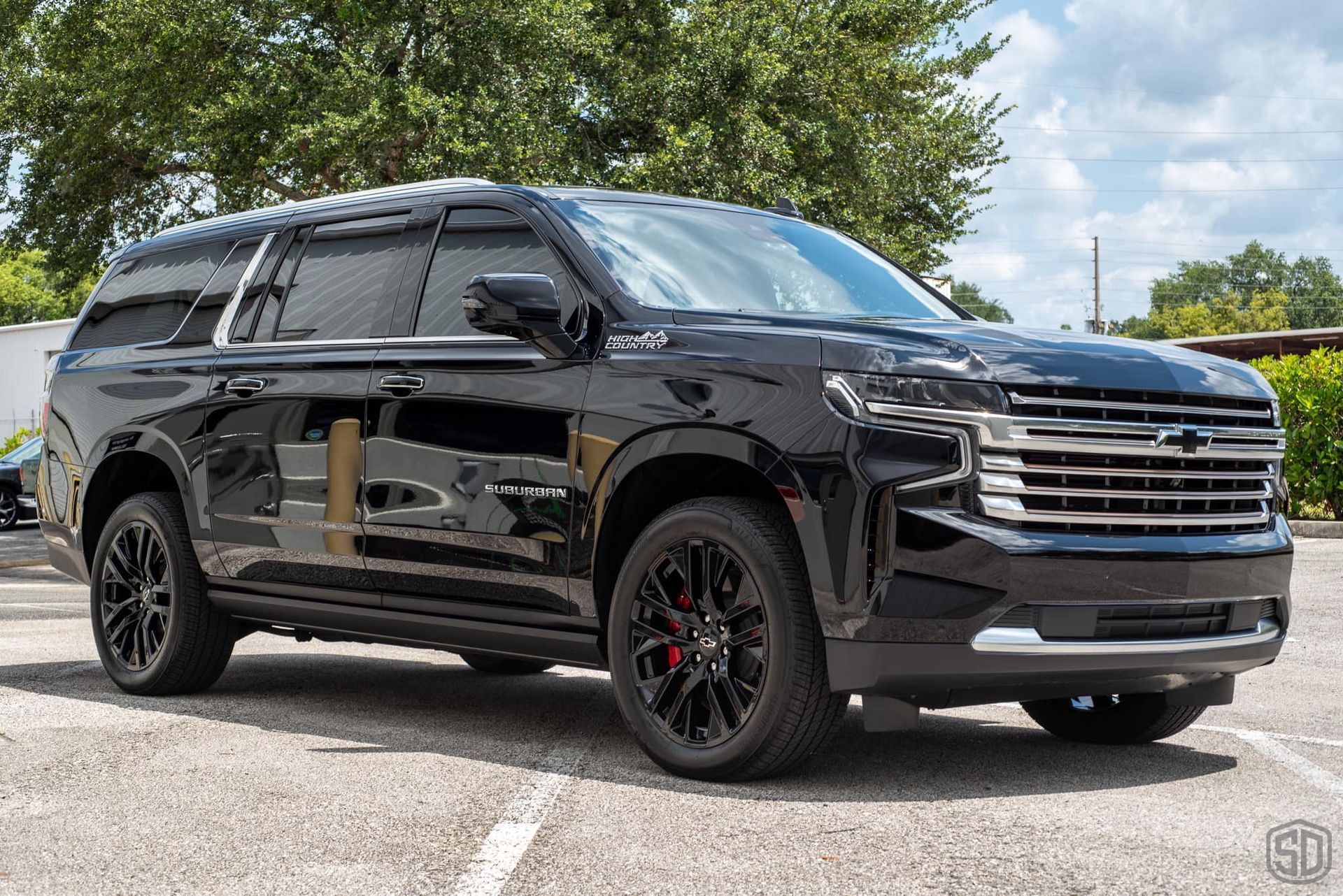 A black suv is parked in a parking lot.