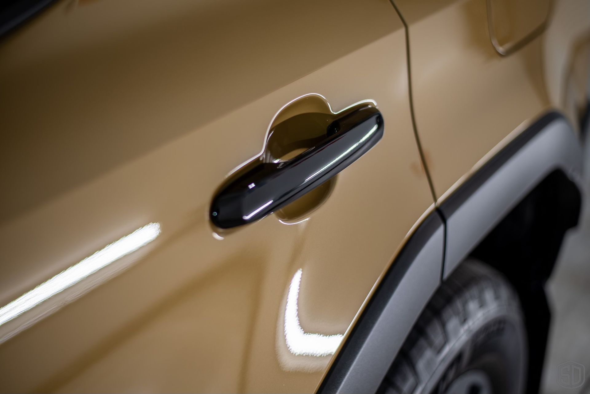 A close up of the door handle of a car.