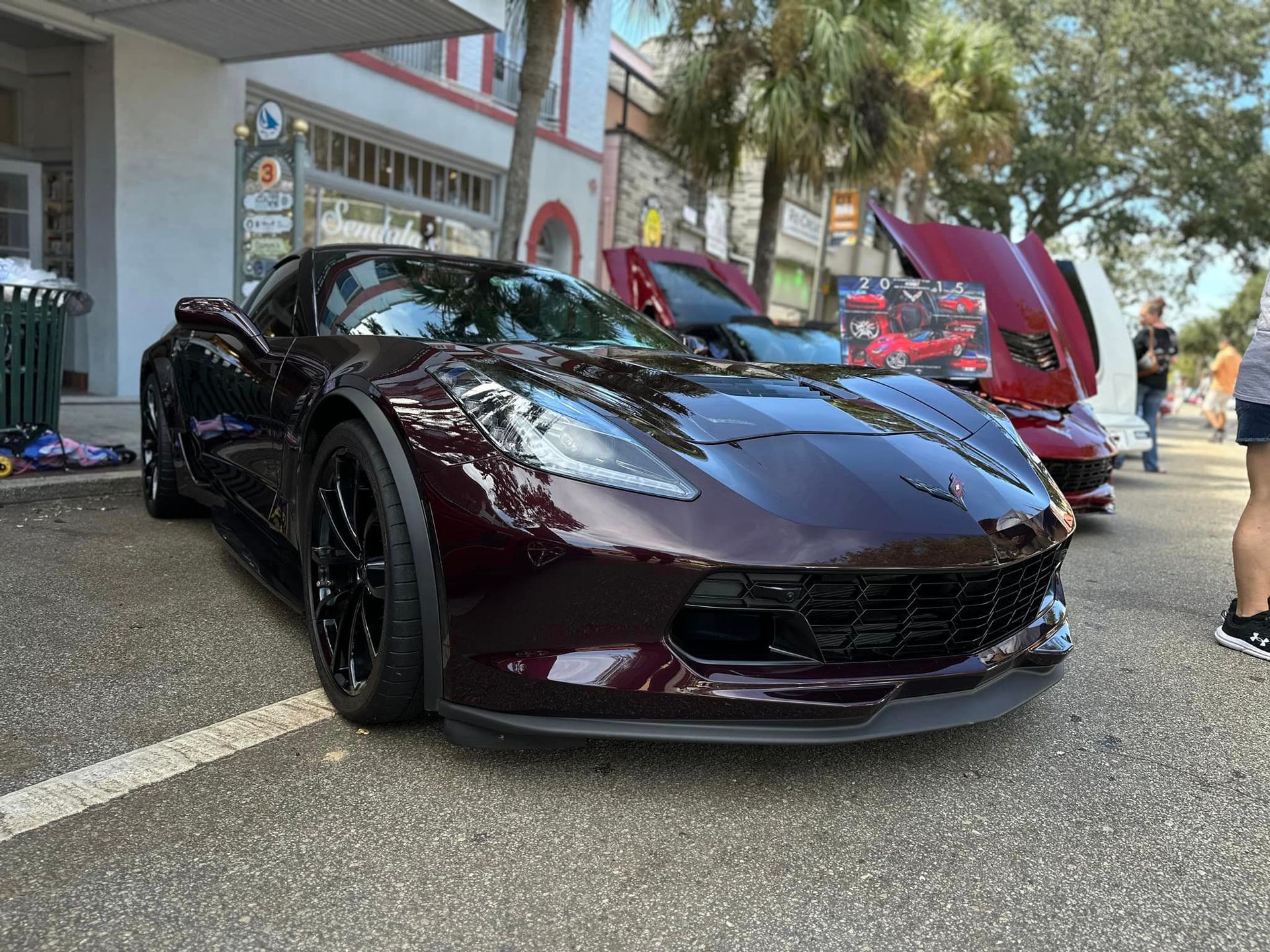 A purple sports car is parked on the side of the road.
