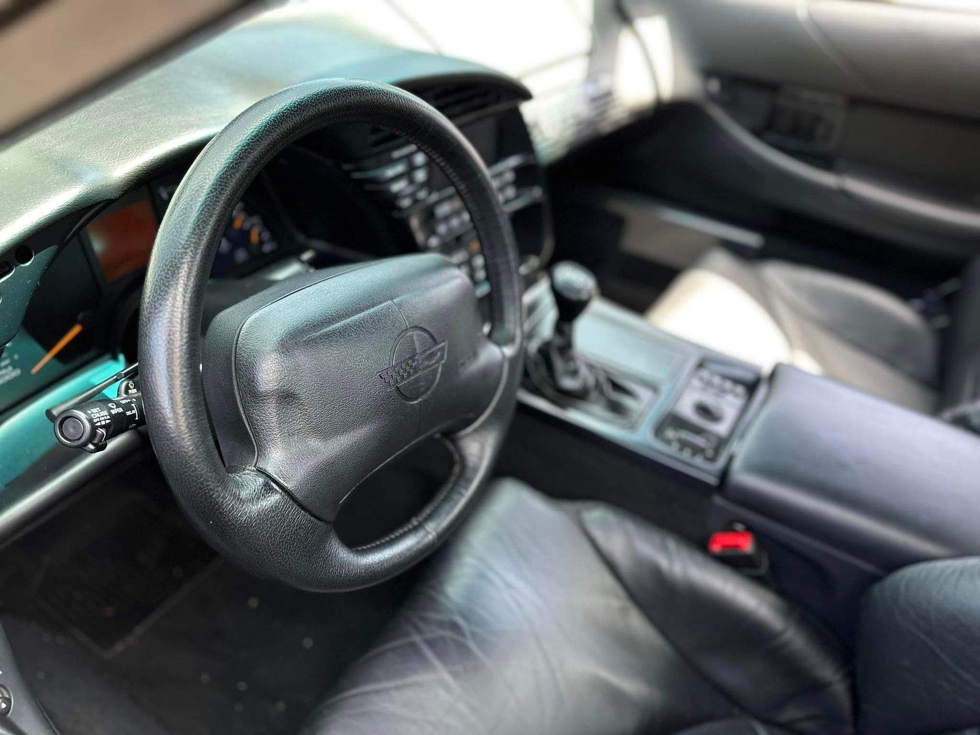 A close up of a steering wheel in a car.