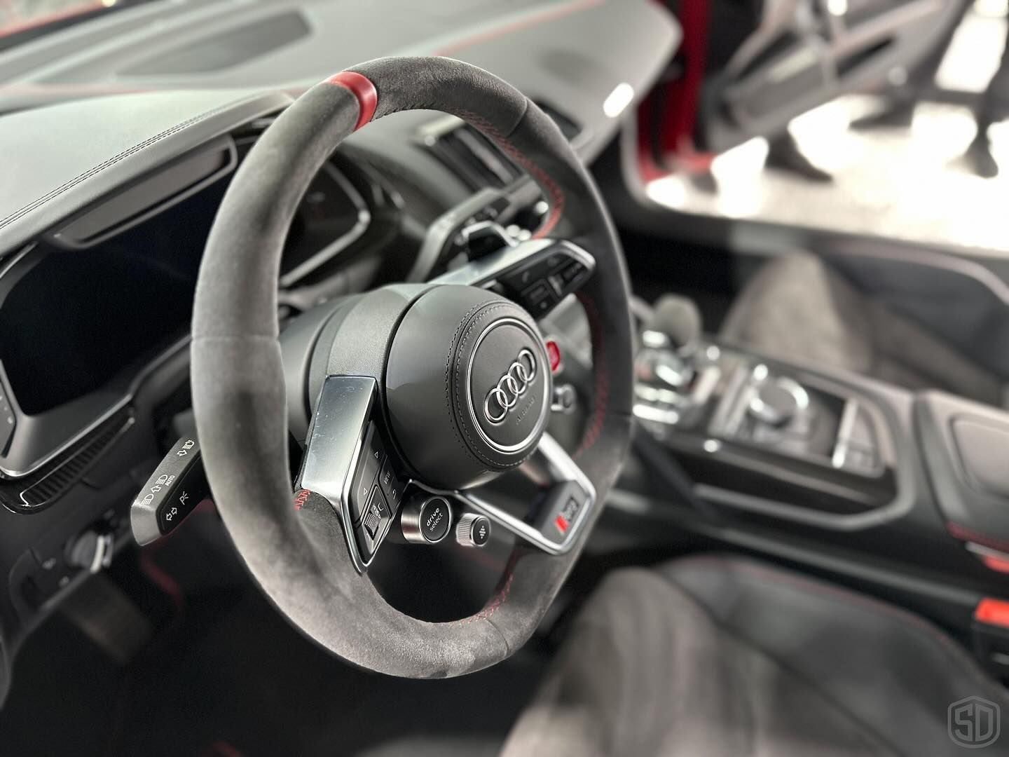 A close up of a steering wheel in a car.