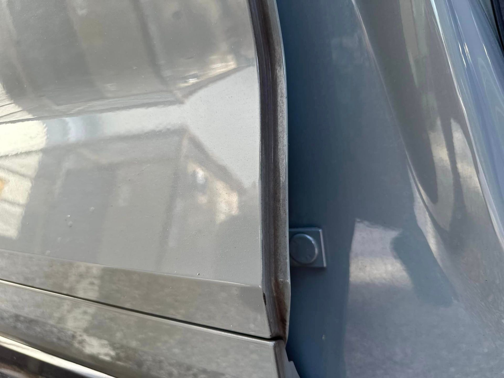 A close up of a car door with a rubber seal on it.