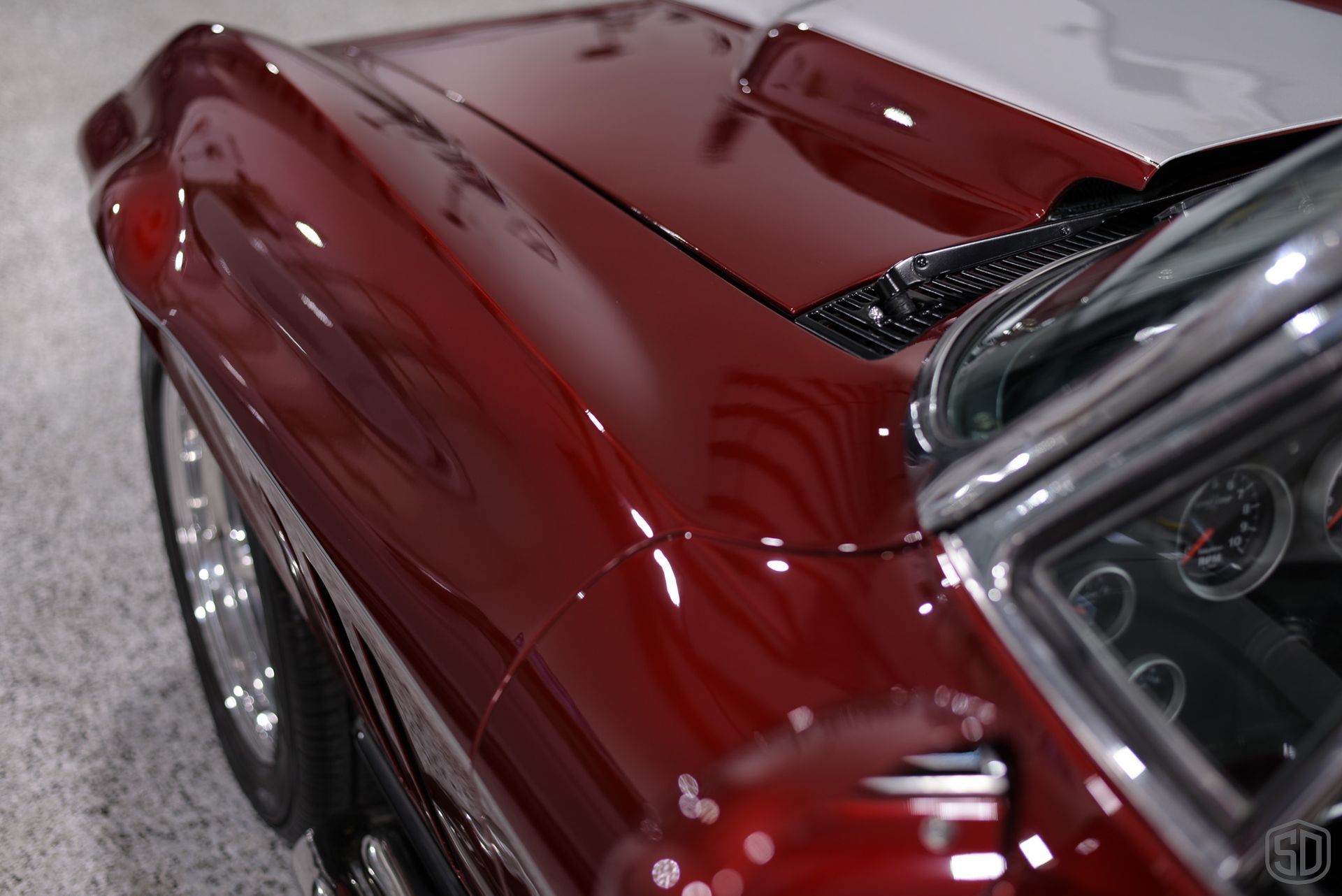A close up of the hood of a red car