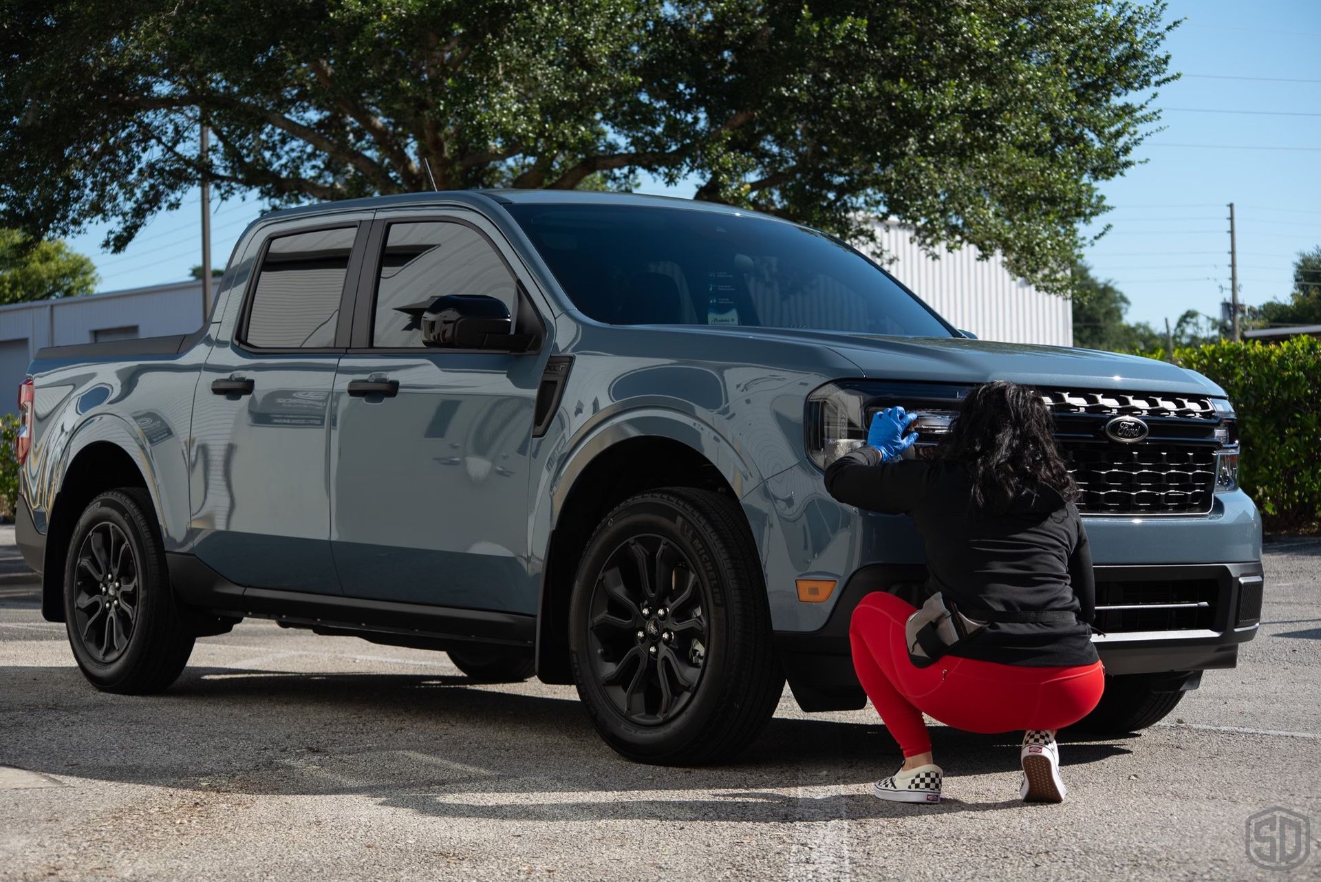 a woman is cleaning a ford maverick