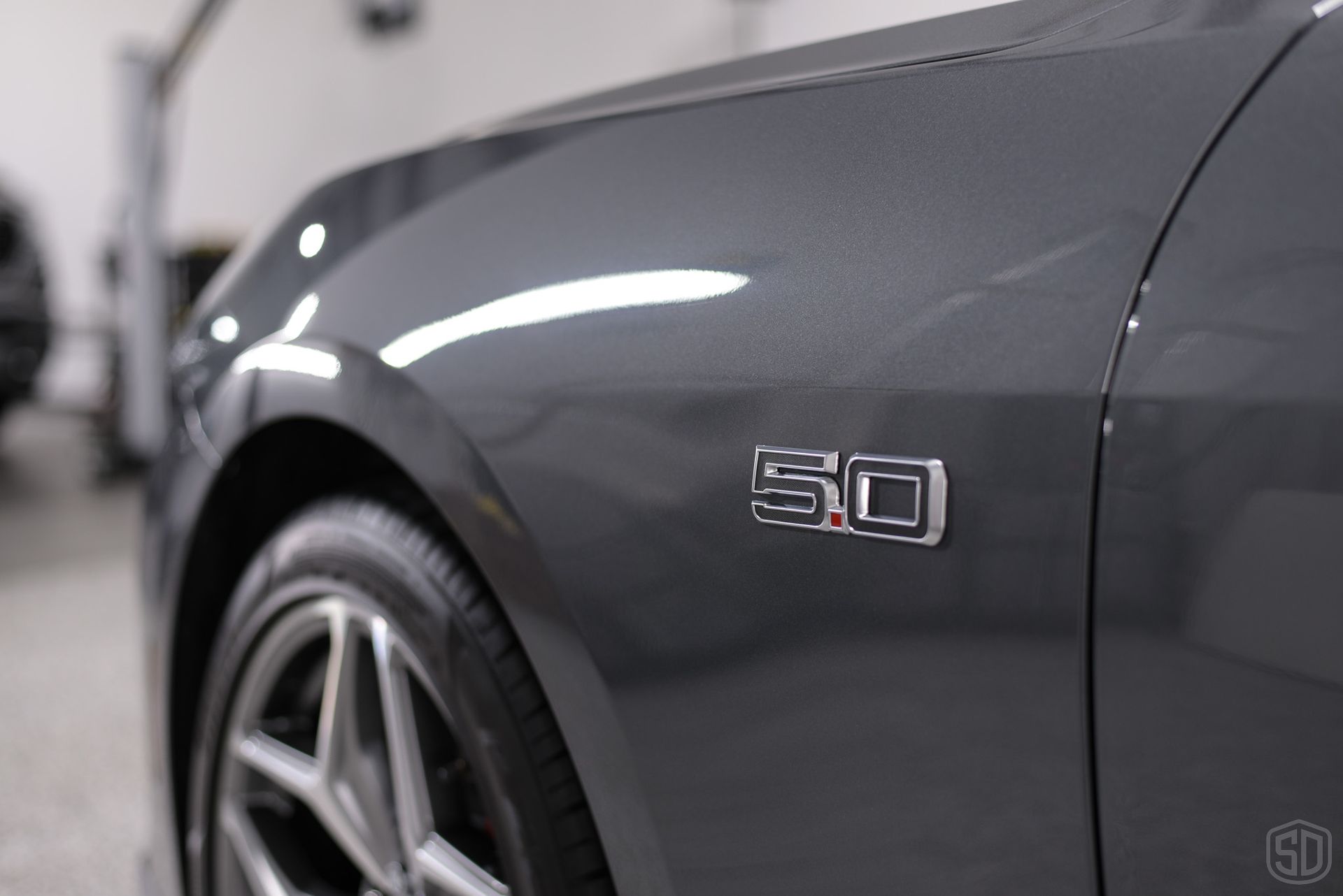 A close up of a ford mustang with the number 50 on the side.