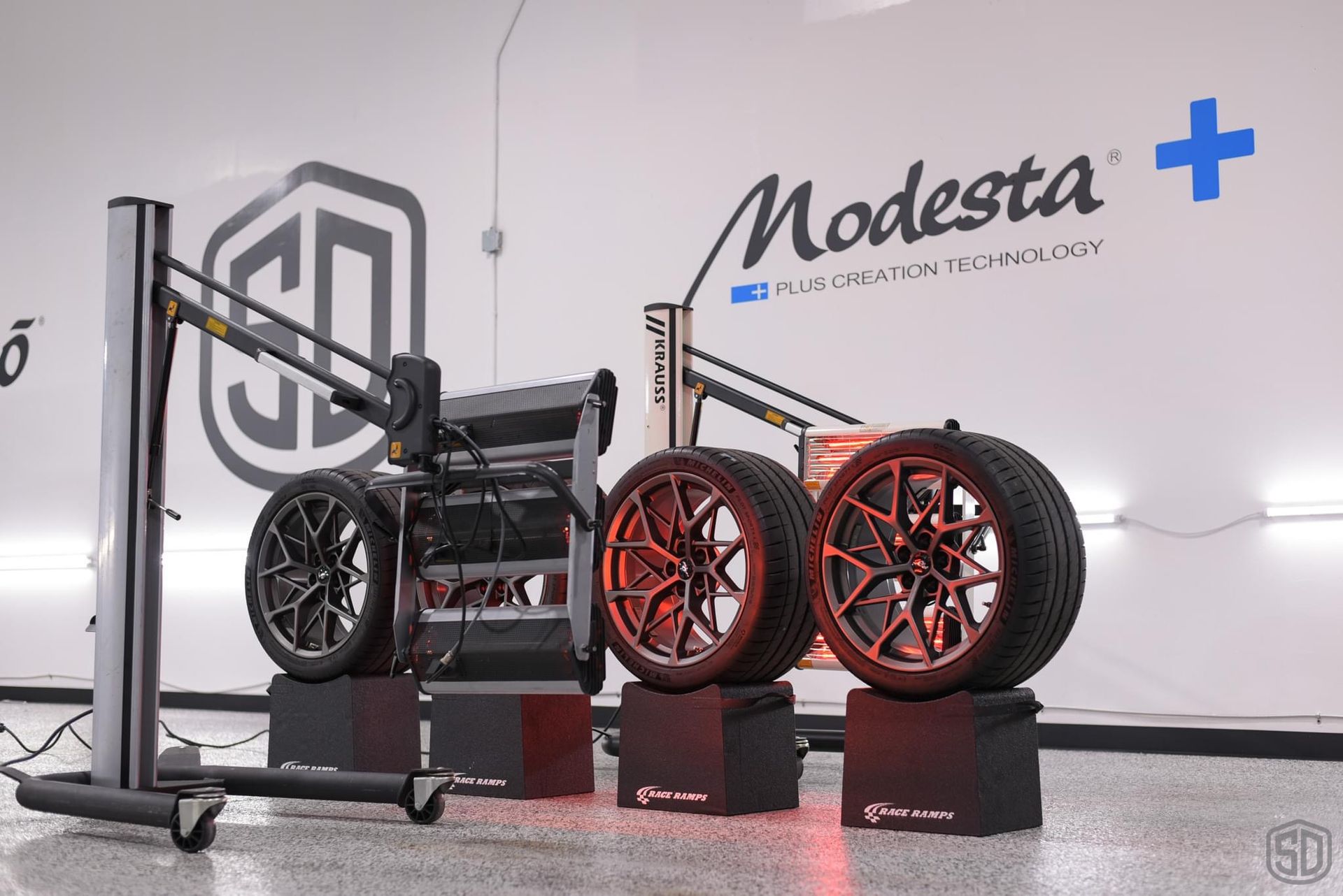A bunch of tires are sitting on top of each other in a garage.