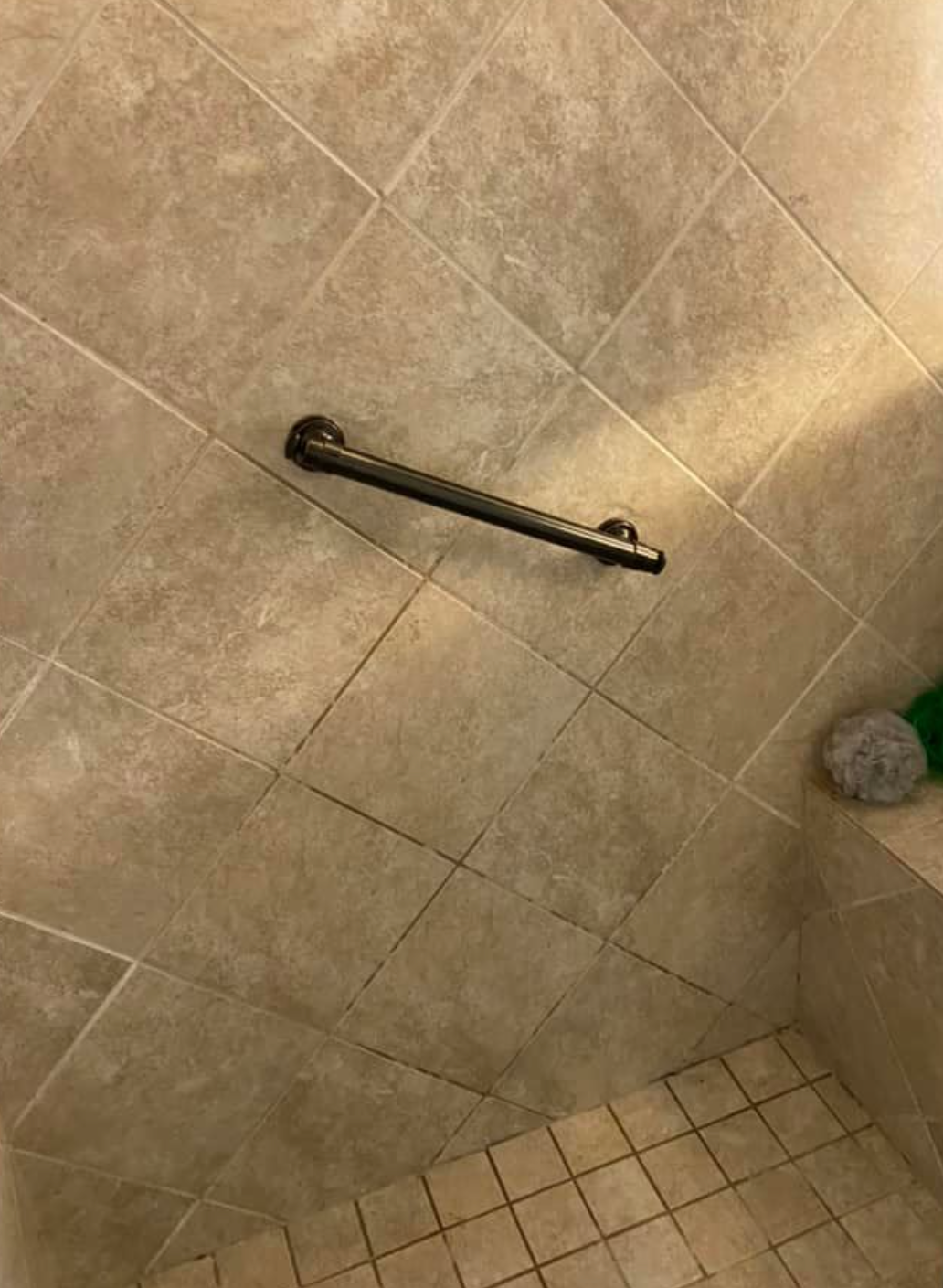 Handrail on a tiled shower wall, for support.