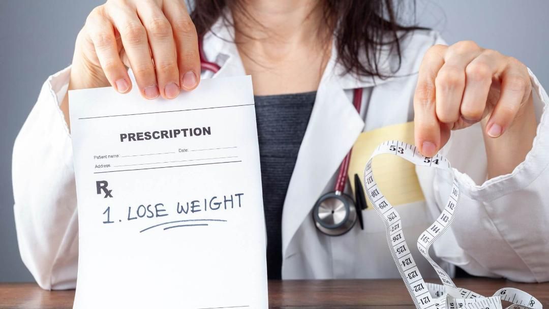 Doctor holding a prescription that says 