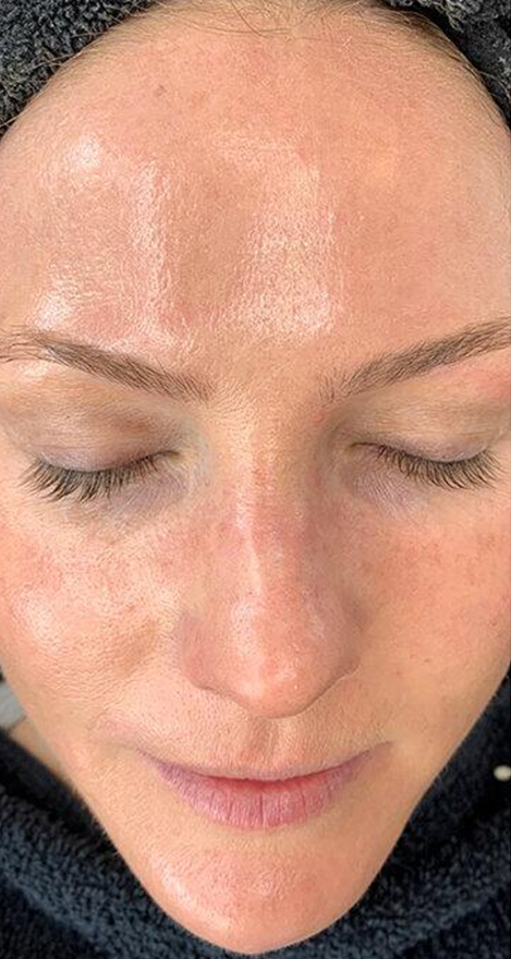 A close up of a woman 's face with her eyes closed.