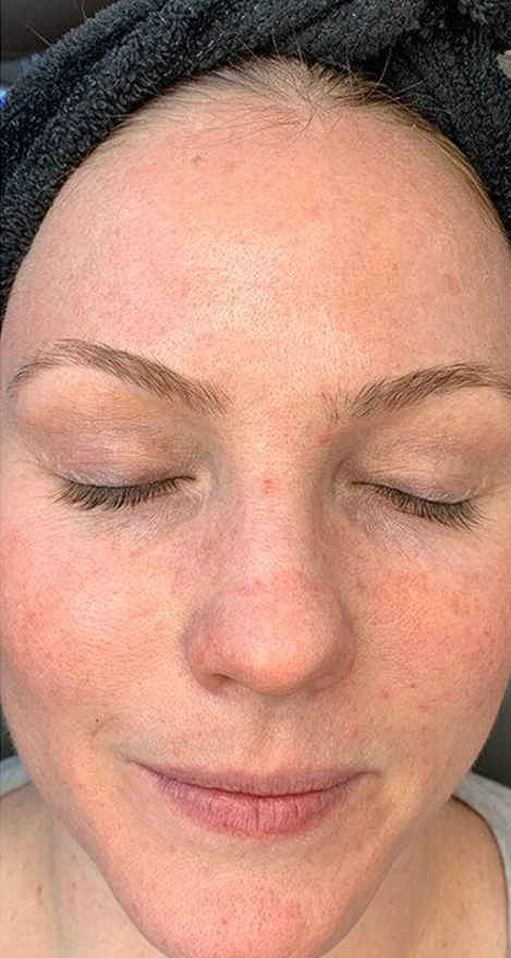 A close up of a woman 's face with her eyes closed.