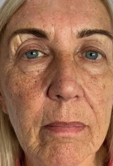 A close up of a woman 's face with a serious look on her face.