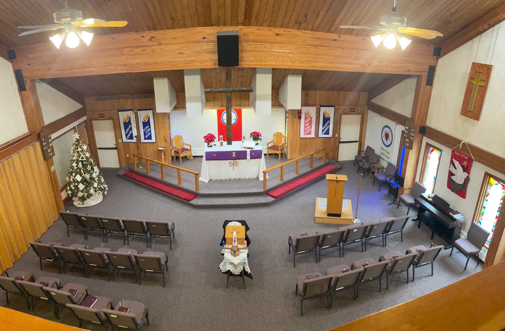 An aerial view of a church with a podium and a christmas tree