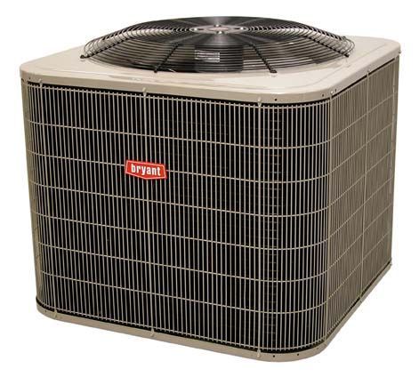 Bryant air conditioning unit outdoors with metal fan and black side panels.