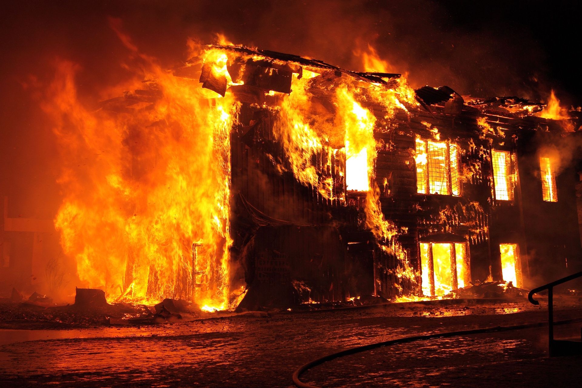 Building on fire with flames on every wall and window
