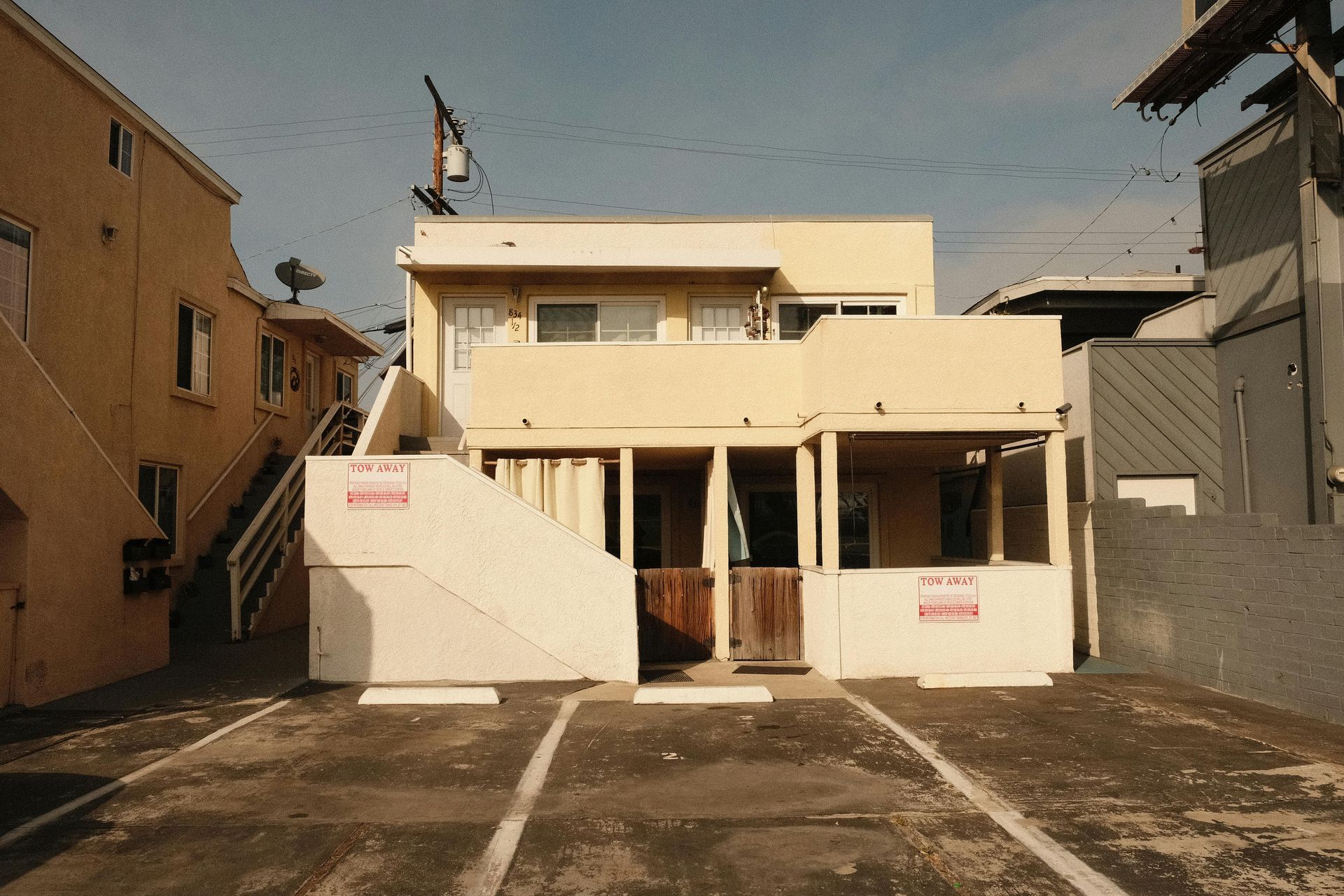 Empty parking stalls behind an Apartment