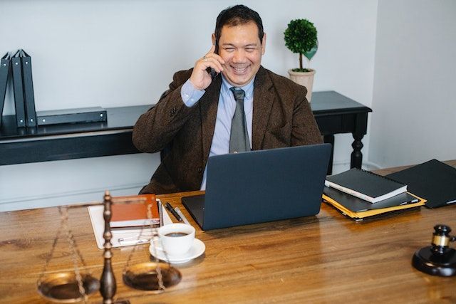 person laughing while on a phone call