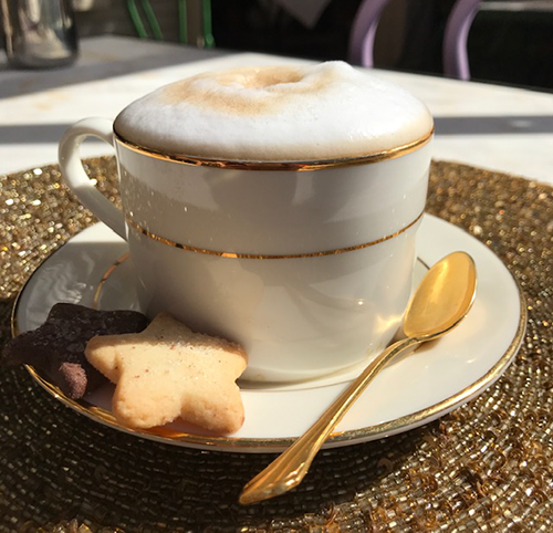 Cappuccino in a delicate white tea cup