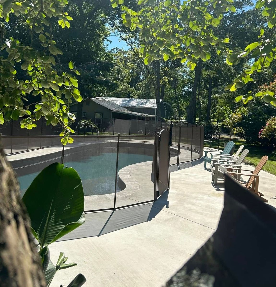 A swimming pool with a fence around it and a gate