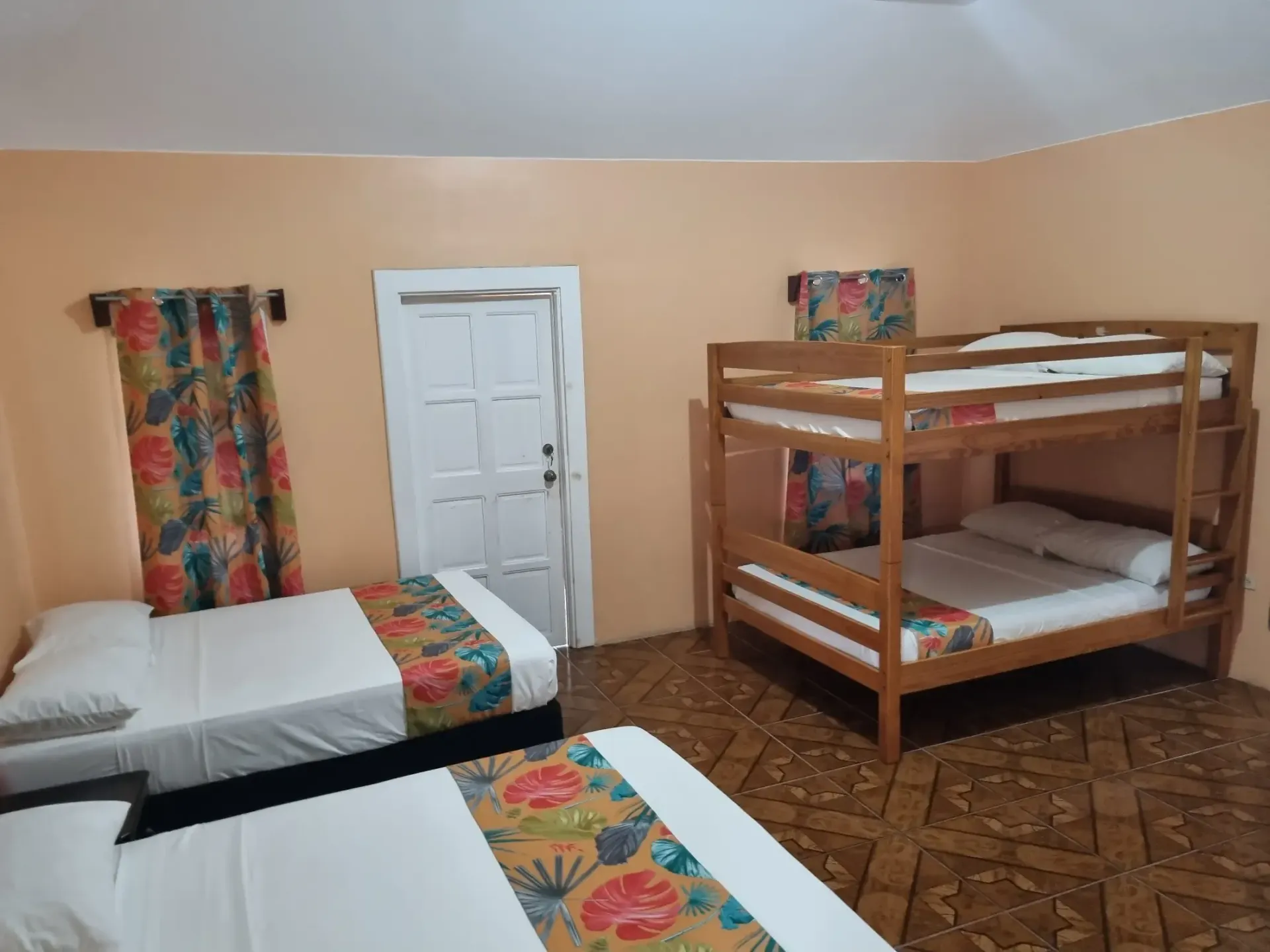 A bedroom with two beds and two bunk beds