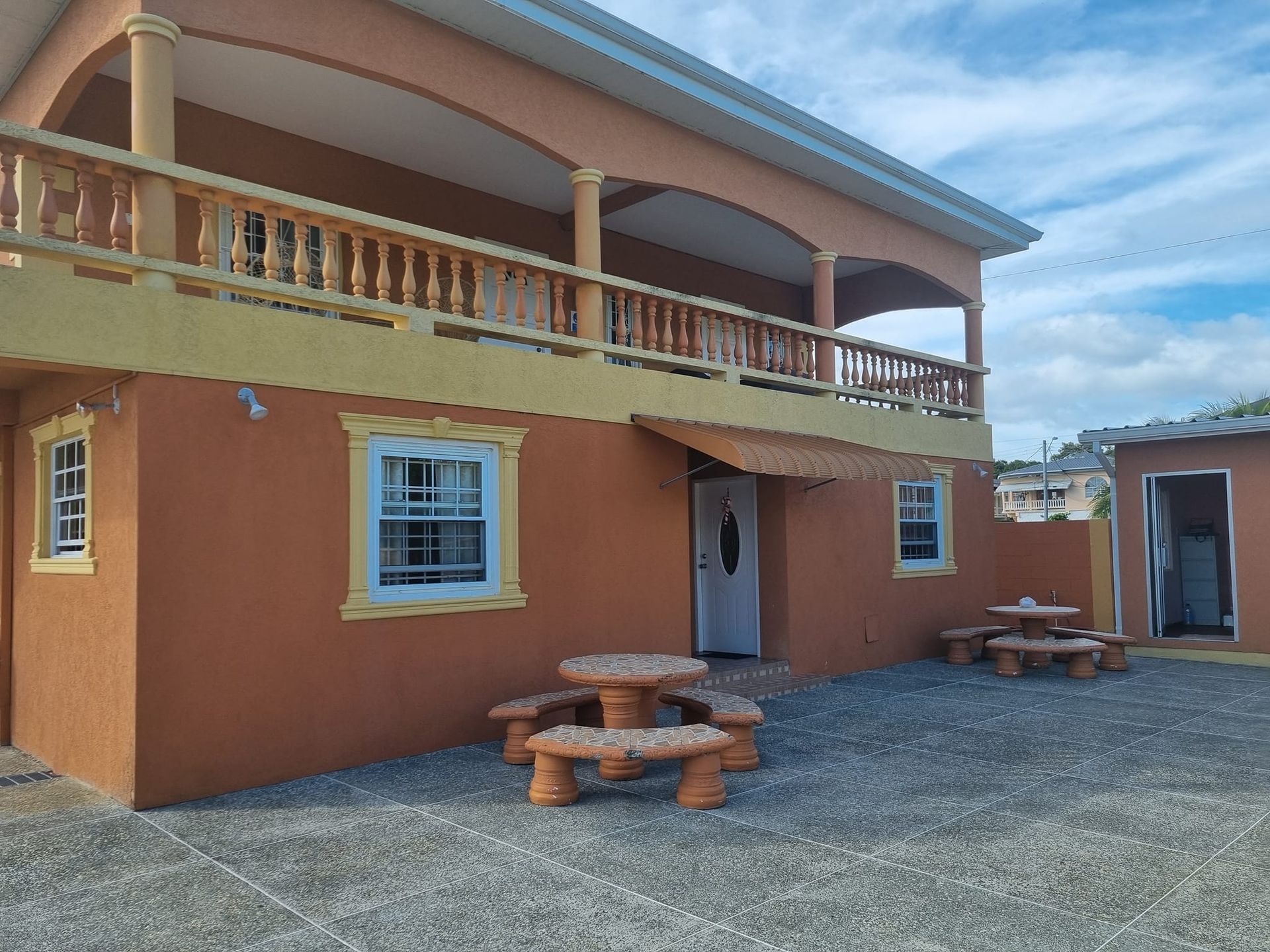 A large house with a picnic table in front of it