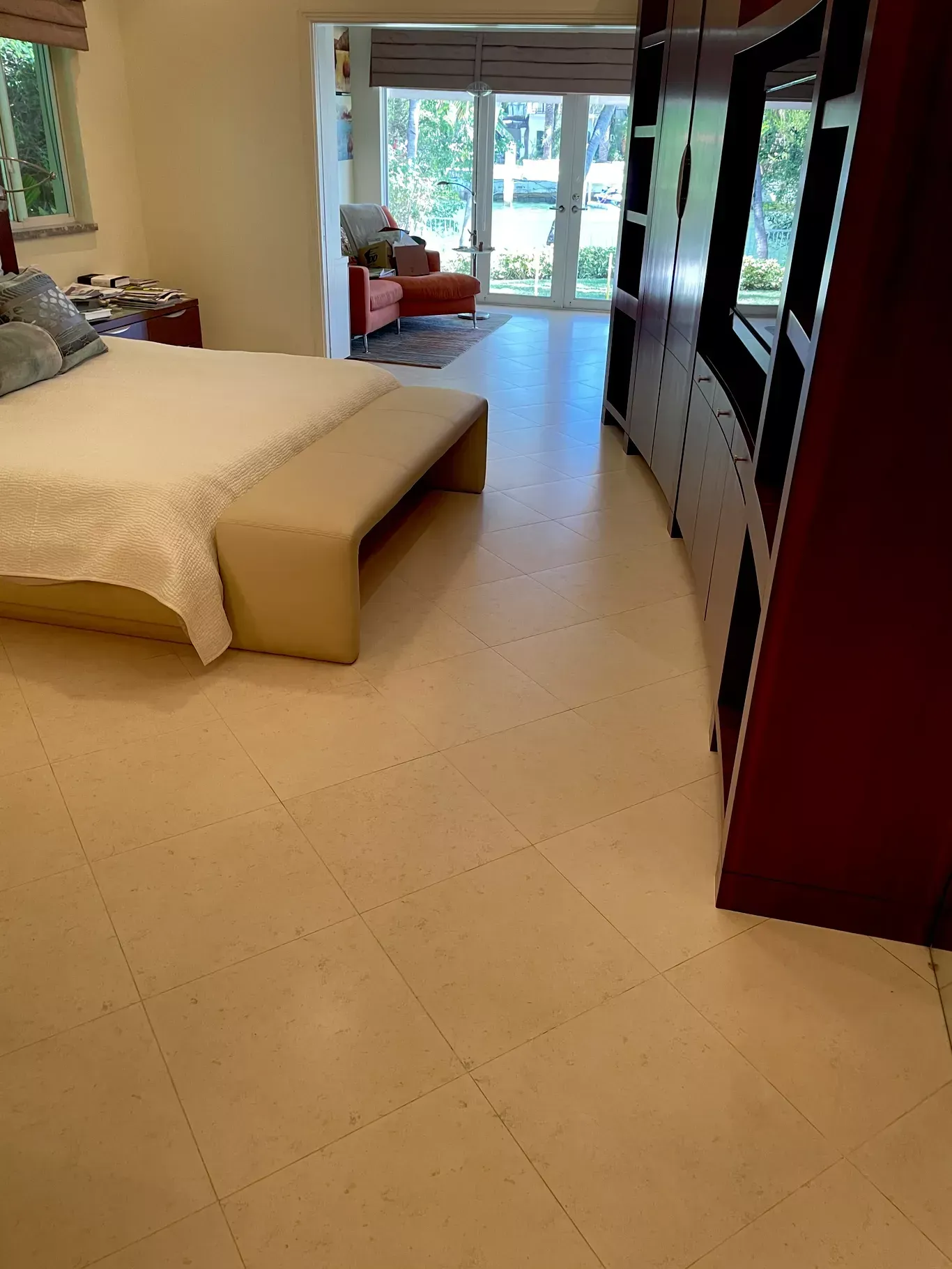 Spacious bedroom with a bed, wardrobe, and sliding glass doors to a garden patio.