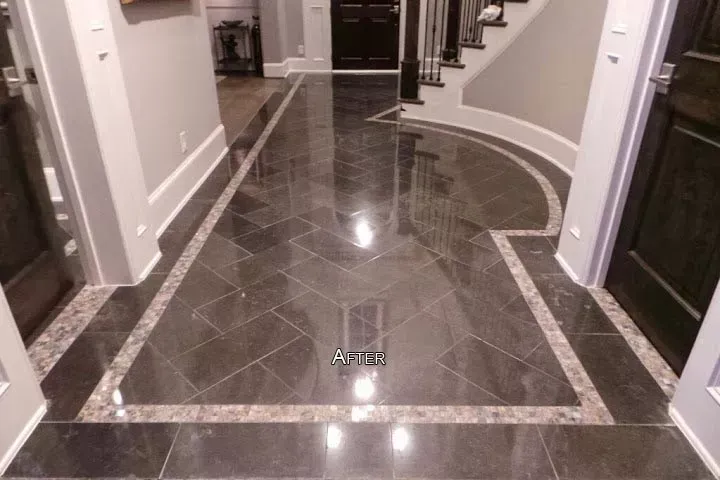 Glossy dark tile hallway with curved white walls and decorative stone border pattern