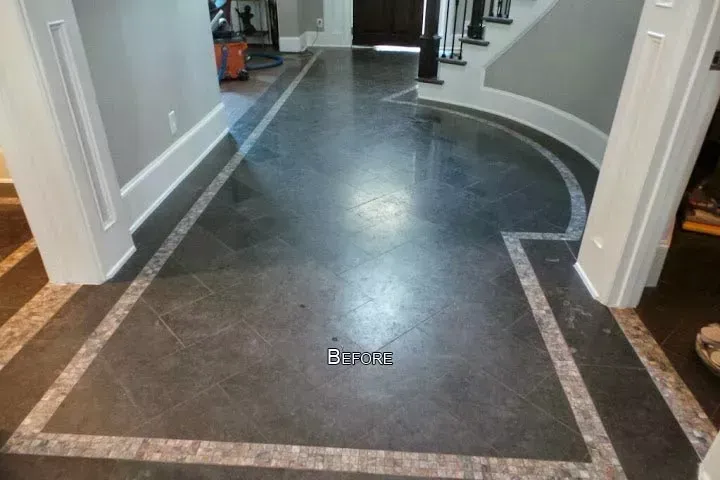 Curved hallway with polished dark tile floor and light walls in a modern interior.