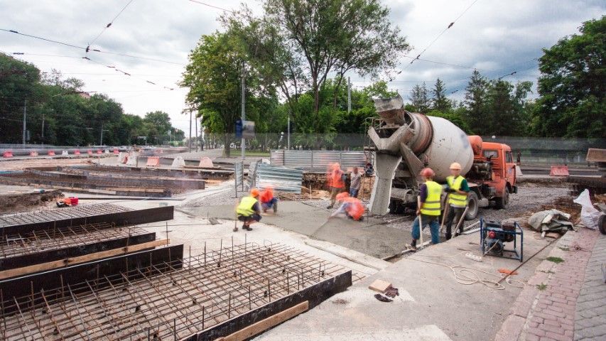 a picture of a cement truck and concrete contractors working