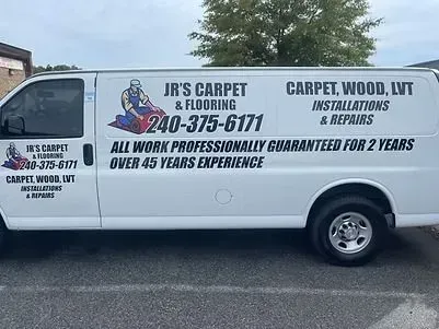 White van with JR's Carpet & Flooring logo, phone number, and services displayed on the side.
