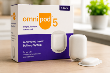 Omnipod 5 insulin delivery system box and pod on a wooden table