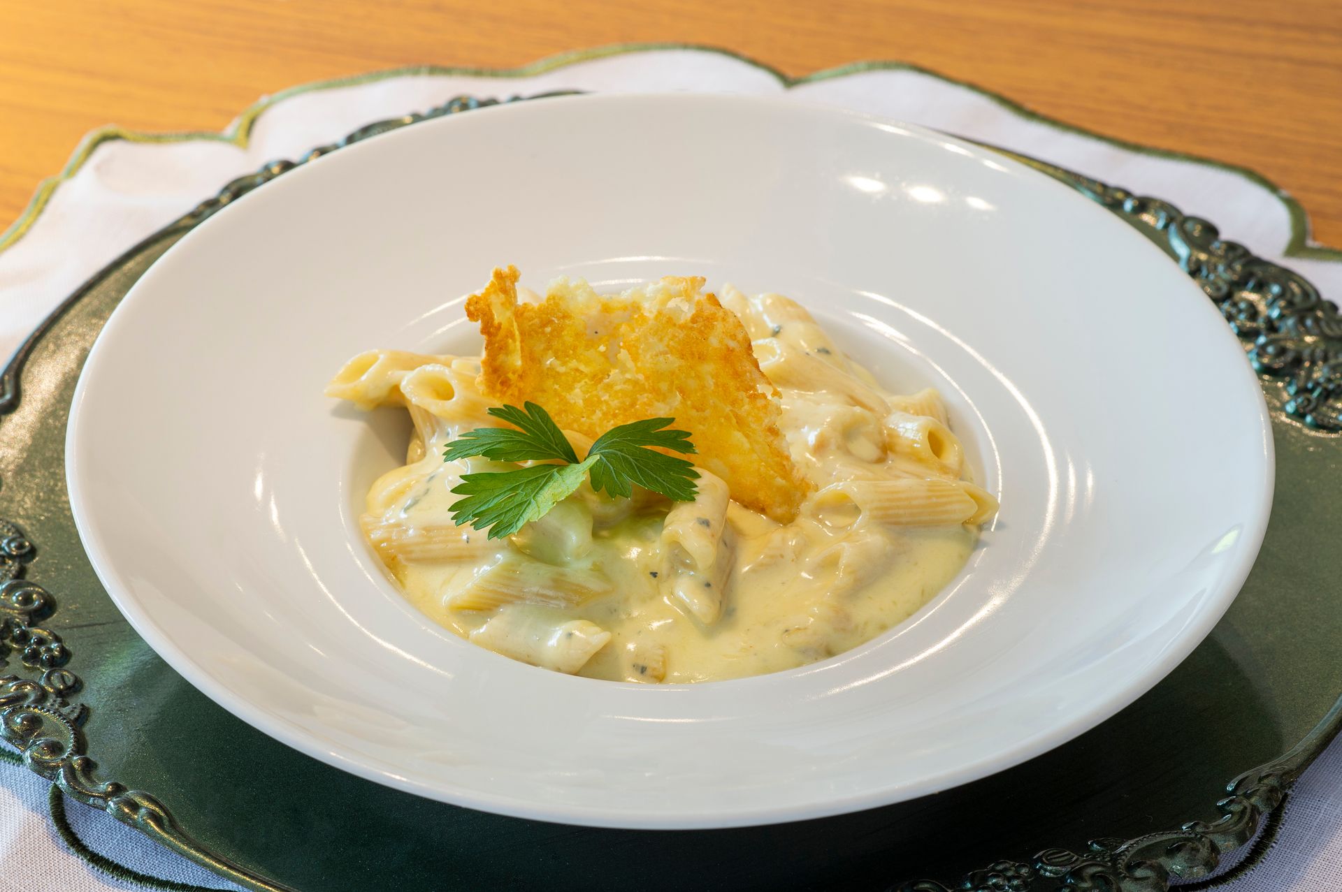 Uma tigela de macarrão com queijo com um pedaço de queijo por cima.
