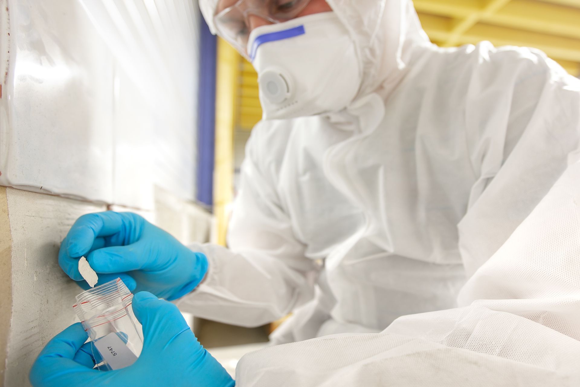 Person in protective suit and gloves taking a sample for building inspection — Scott MacTaggart Building & Pest Inspections In Taree, NSW