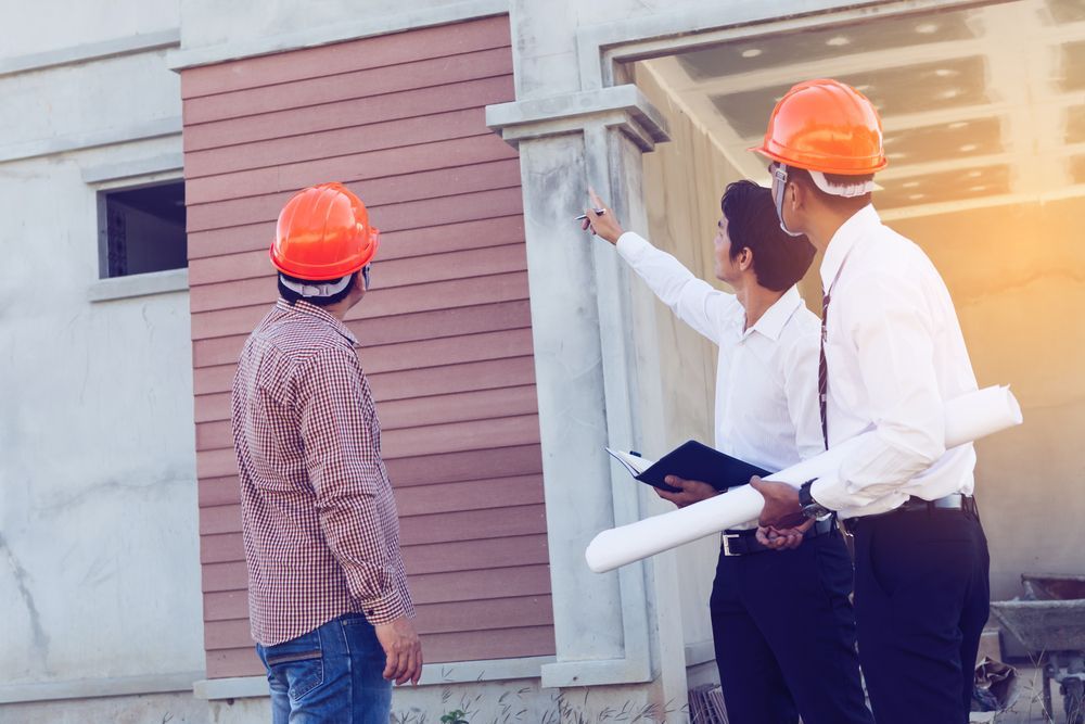 Three Men in Hard Hats Inspecting a Building — Scott MacTaggart Building & Pest Inspections In Wingham, NSW