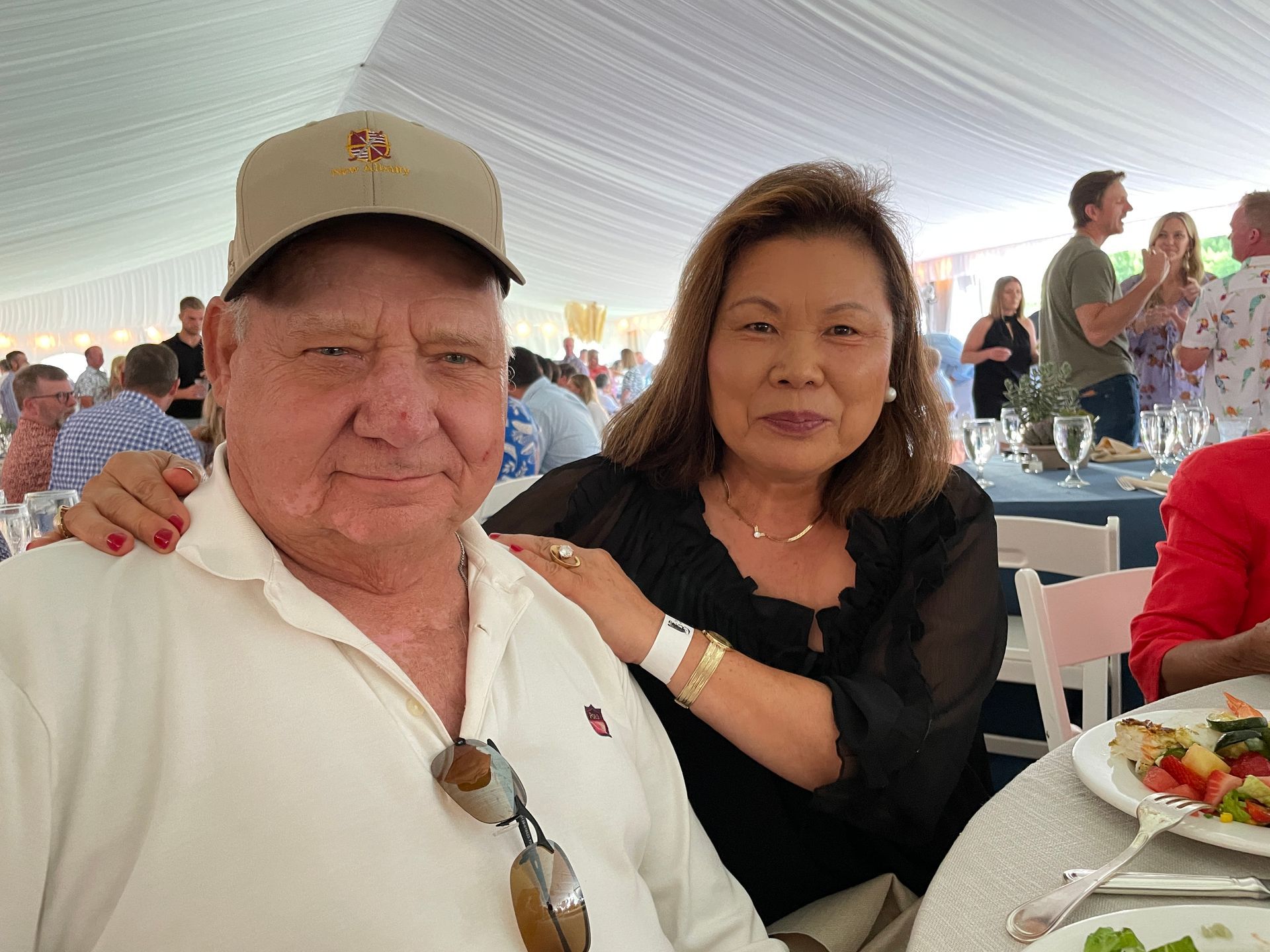People attend a luncheon in a tent