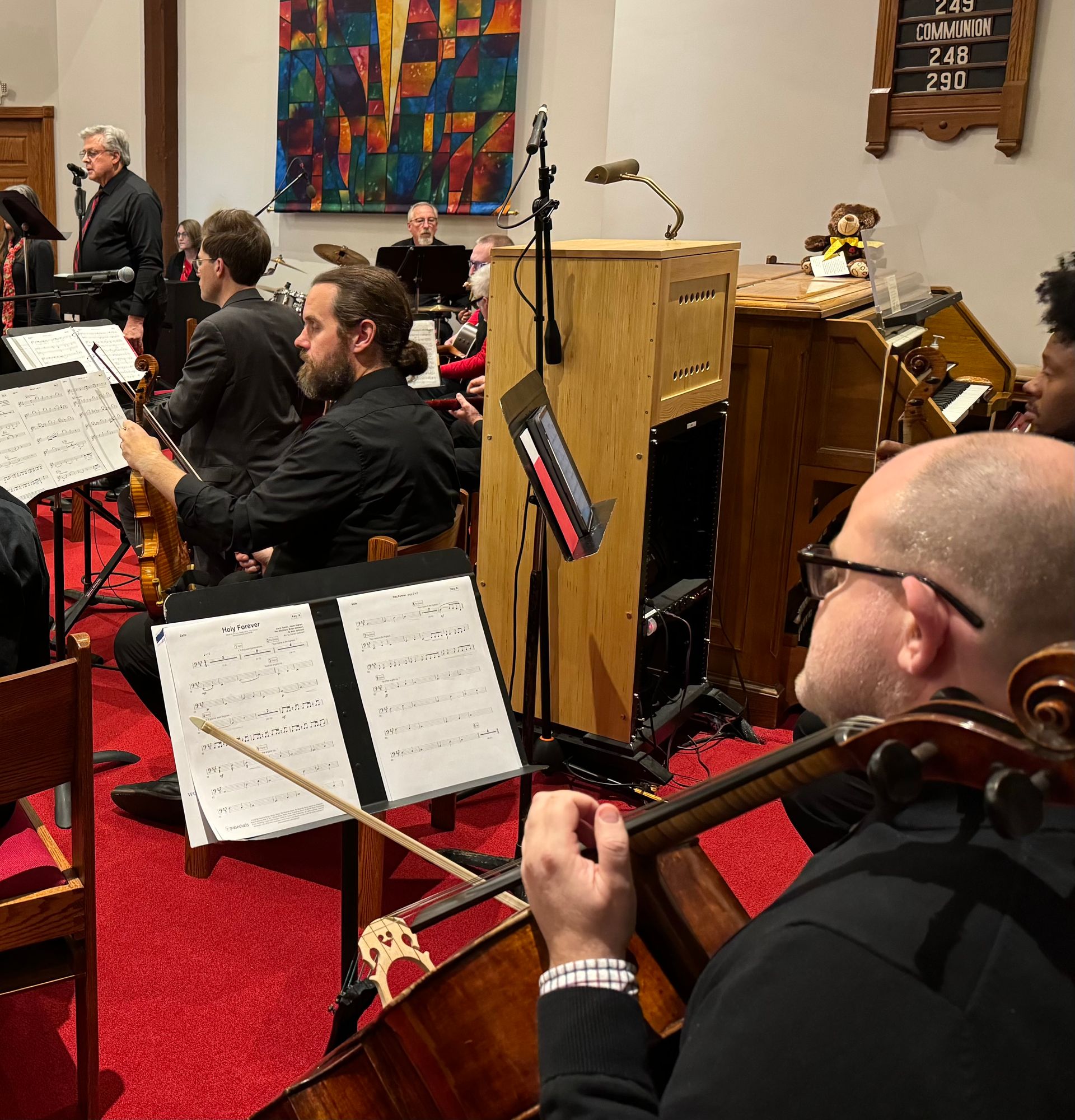 Musicians play in front of a church organ