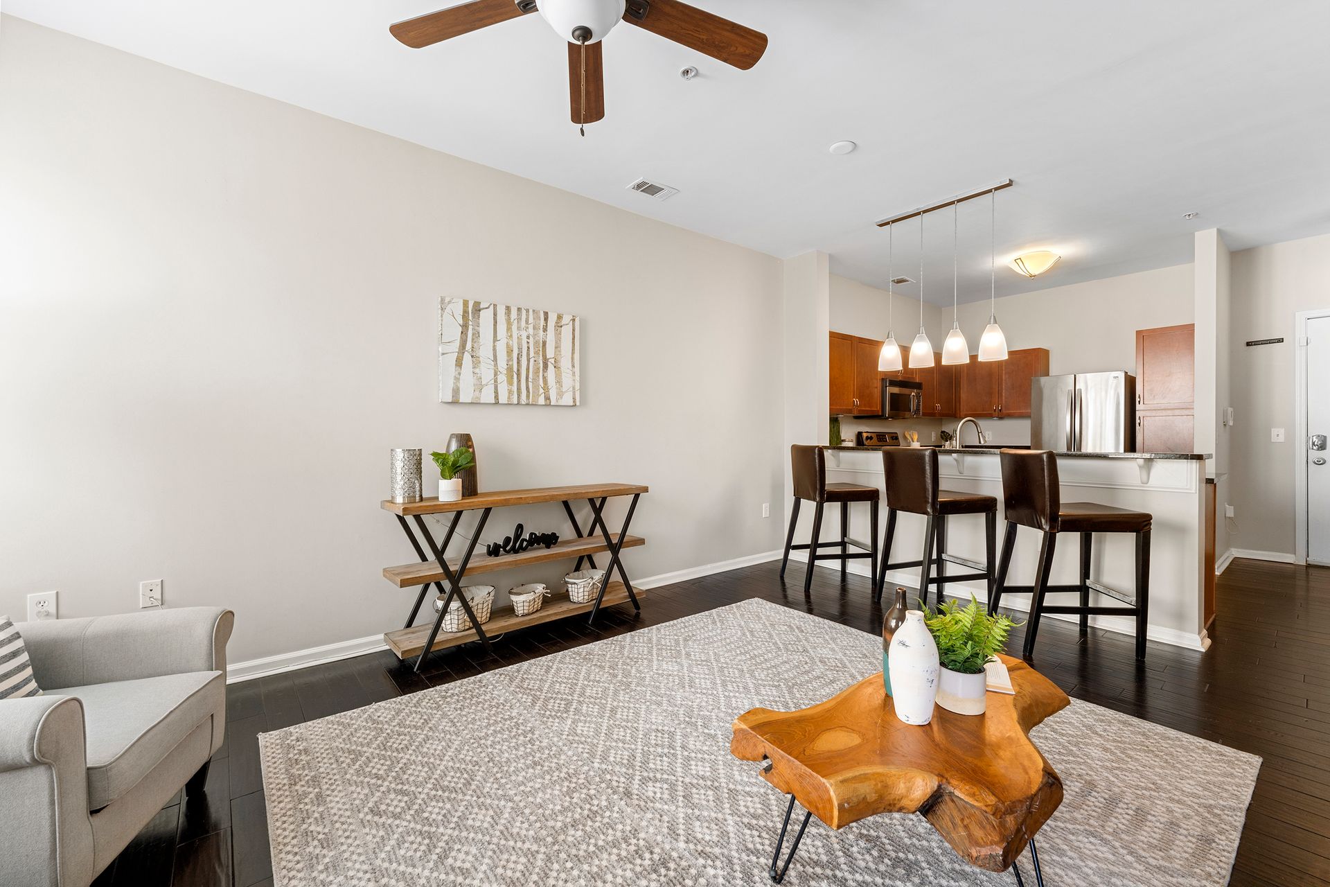 A living room with a wooden coffee table and a ceiling fan.