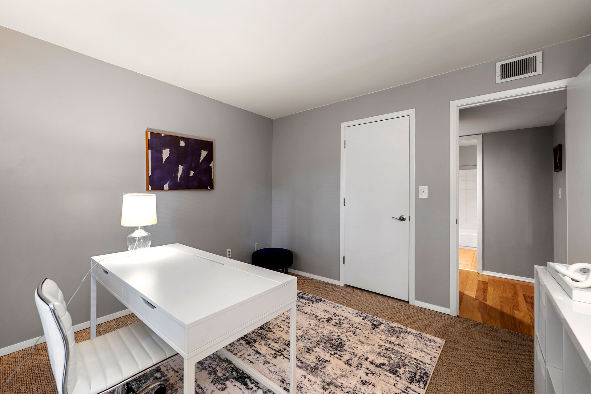 There is a desk and chair in the room.