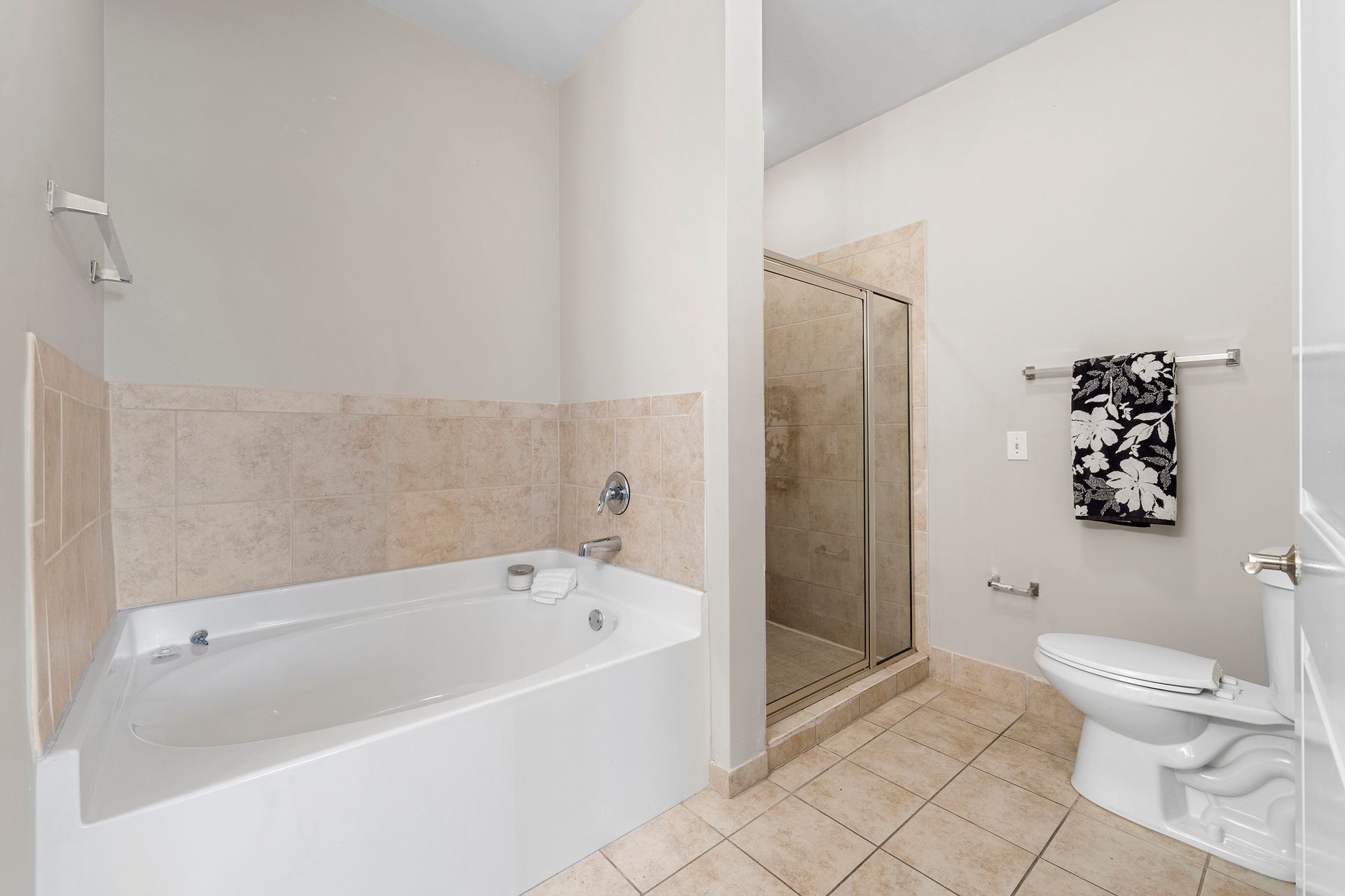 A bathroom with a tub , toilet and shower.