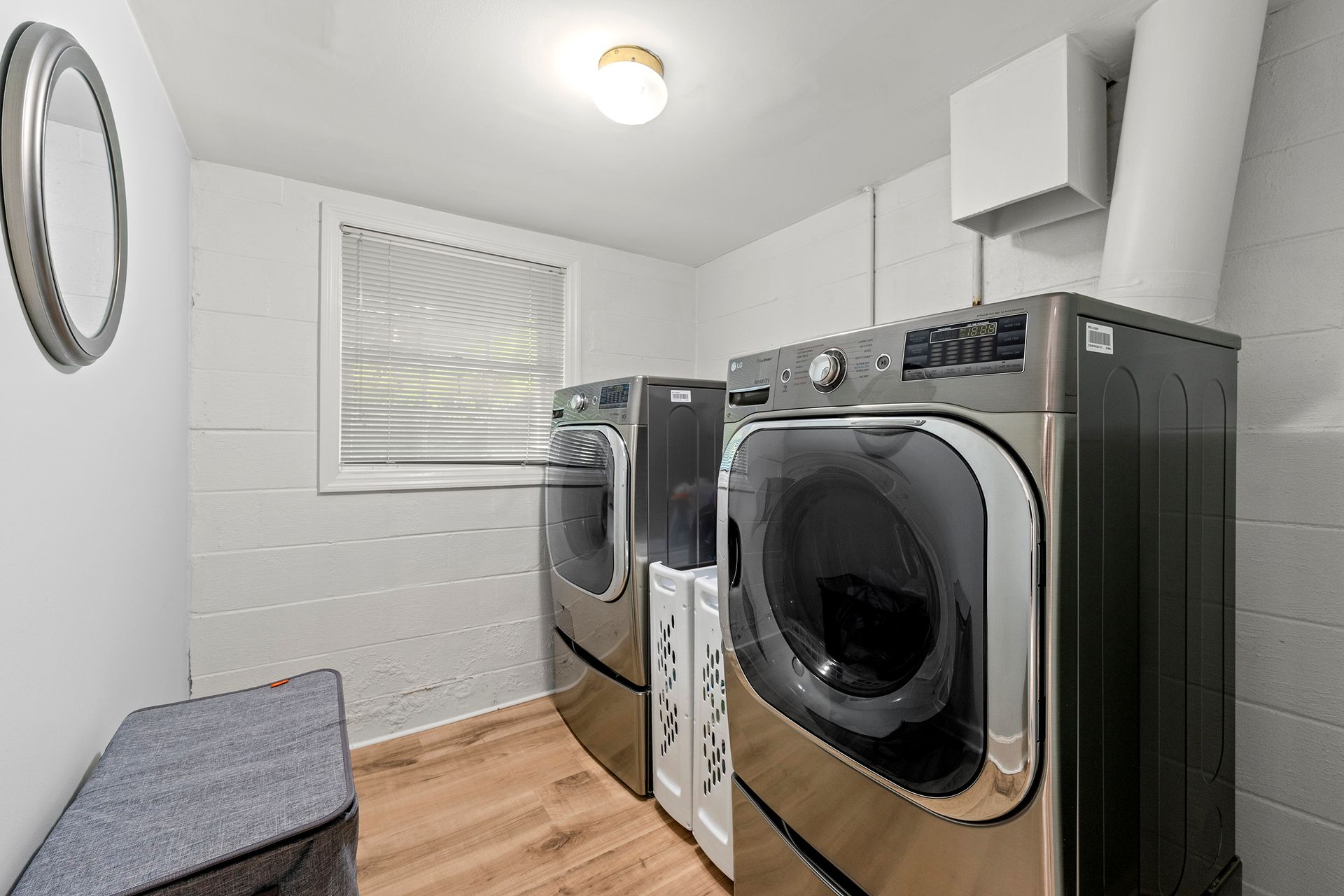 There are two washers and dryers in the laundry room.