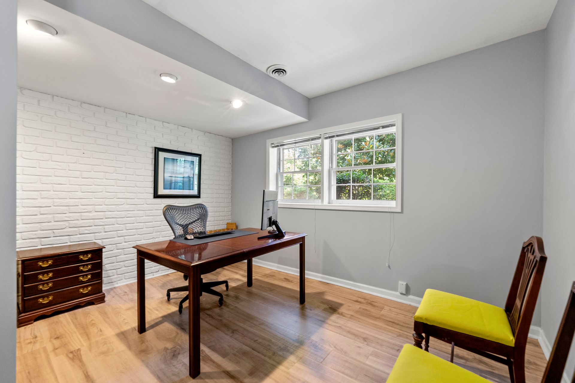 There is a desk and chairs in the room.