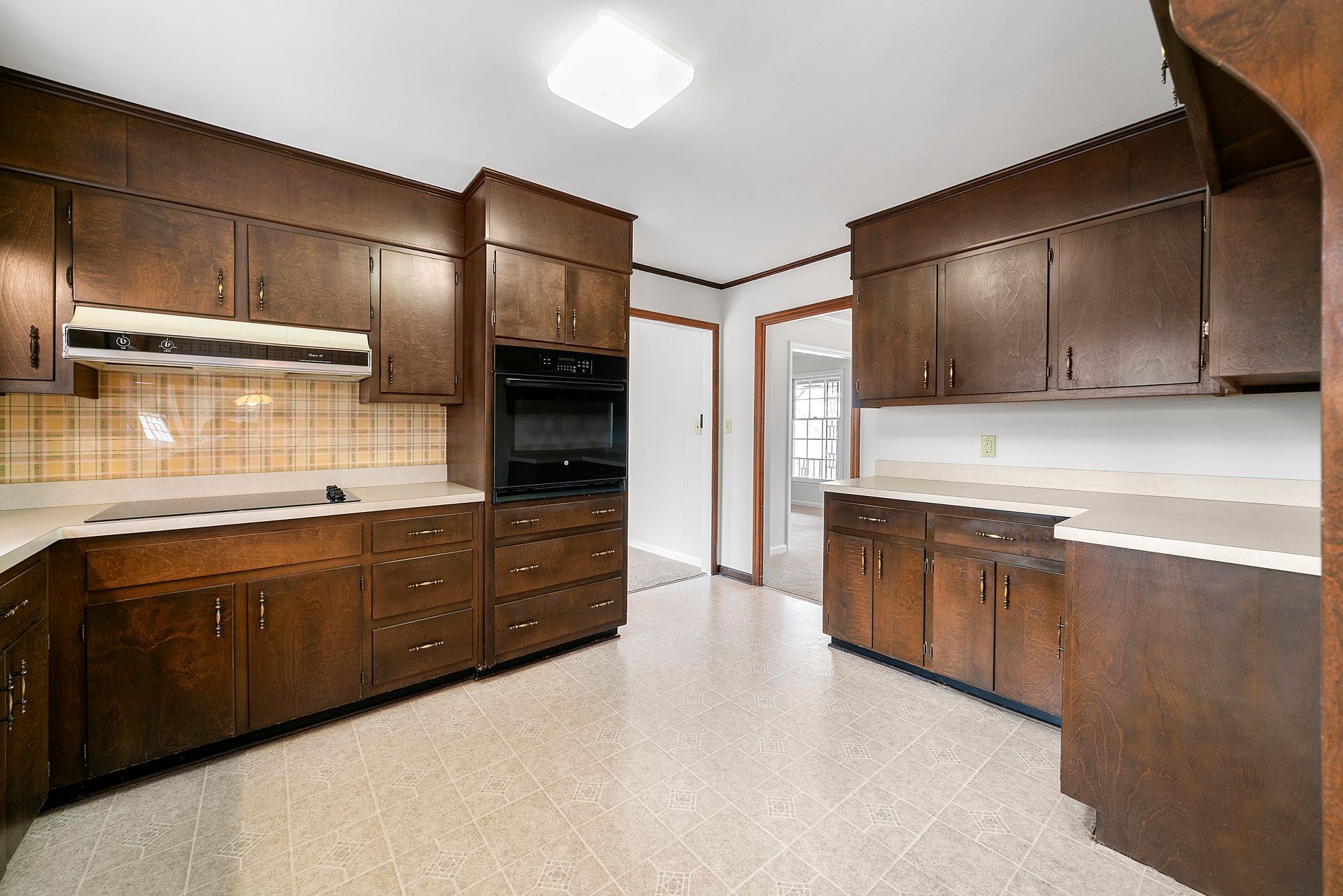 A kitchen with wooden cabinets and granite counter tops