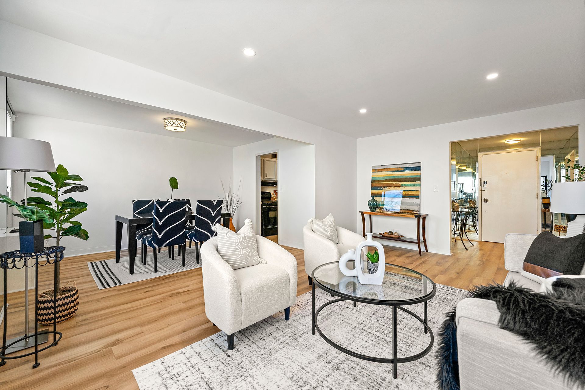 A living room filled with furniture and a glass coffee table.