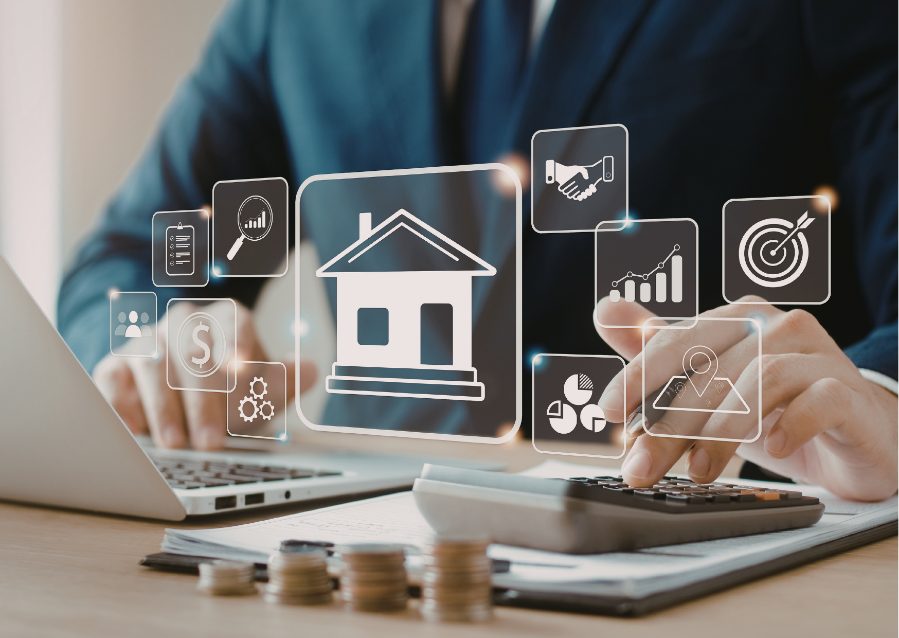 Hands typing on a laptop with floating real estate icons over a desk and calculator