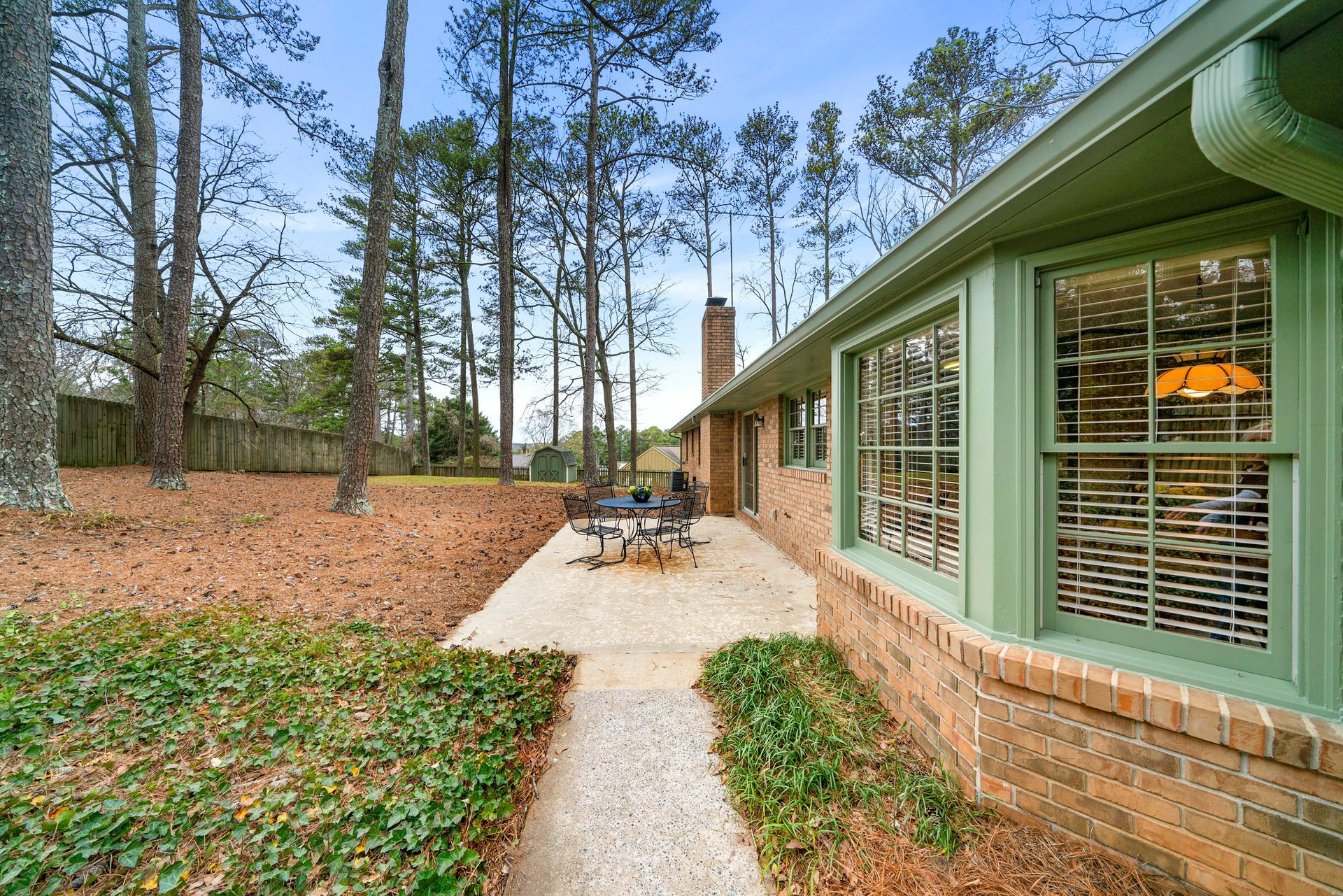 A house with a patio and trees in the background