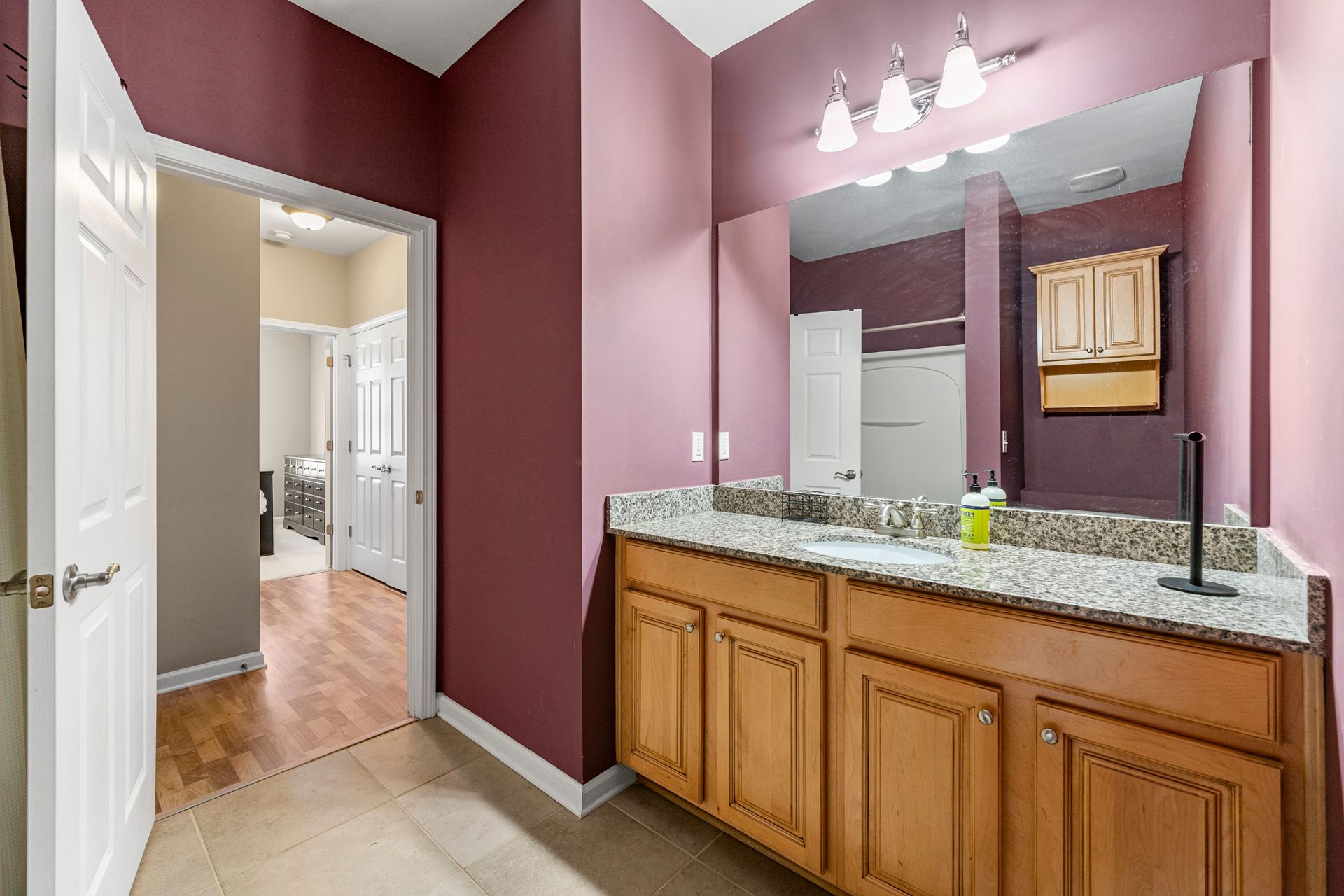 A bathroom with a double sink and a large mirror.