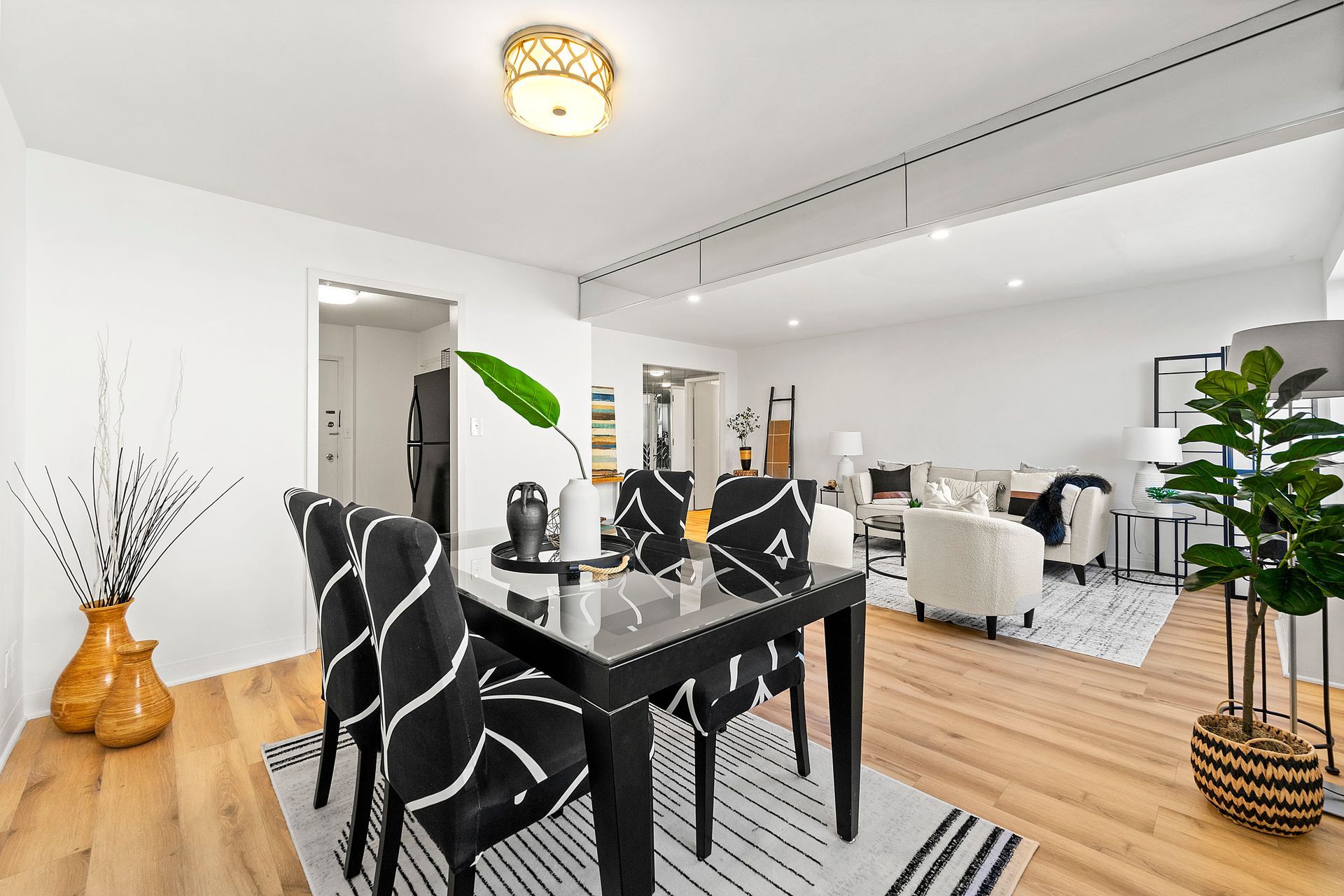 A dining room table and chairs in a living room.